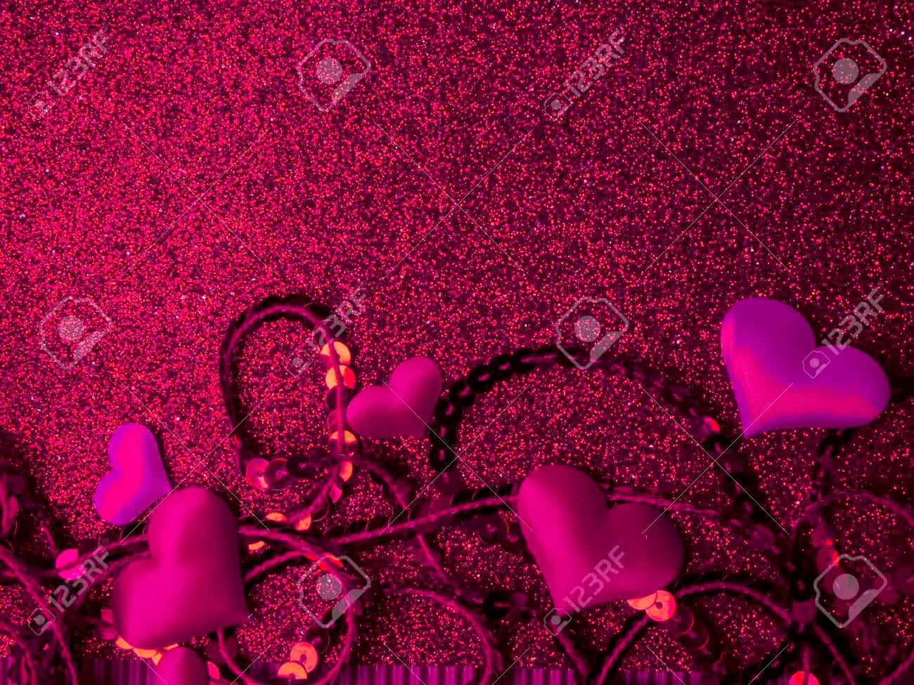 A Sparkling Pink Heart Shines Hope In The Darkness Background