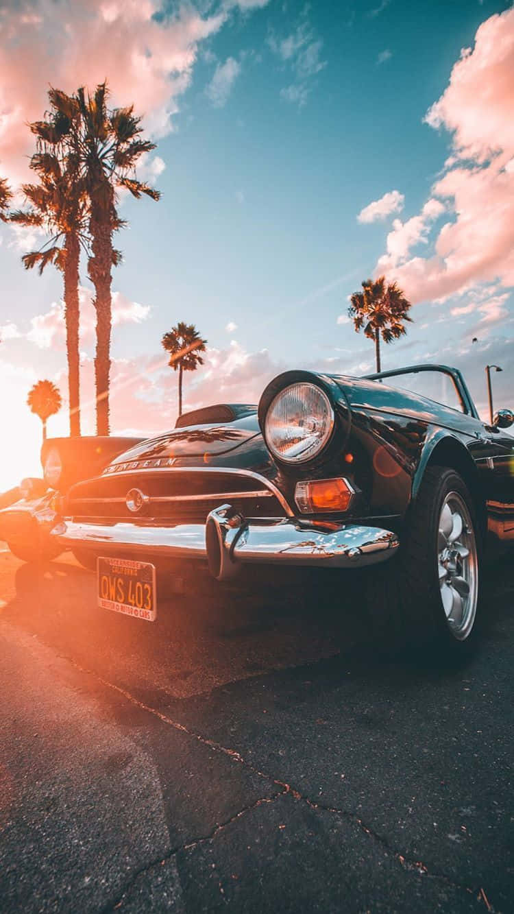 A Spectacular Vintage Car Sitting Next To An Iphone