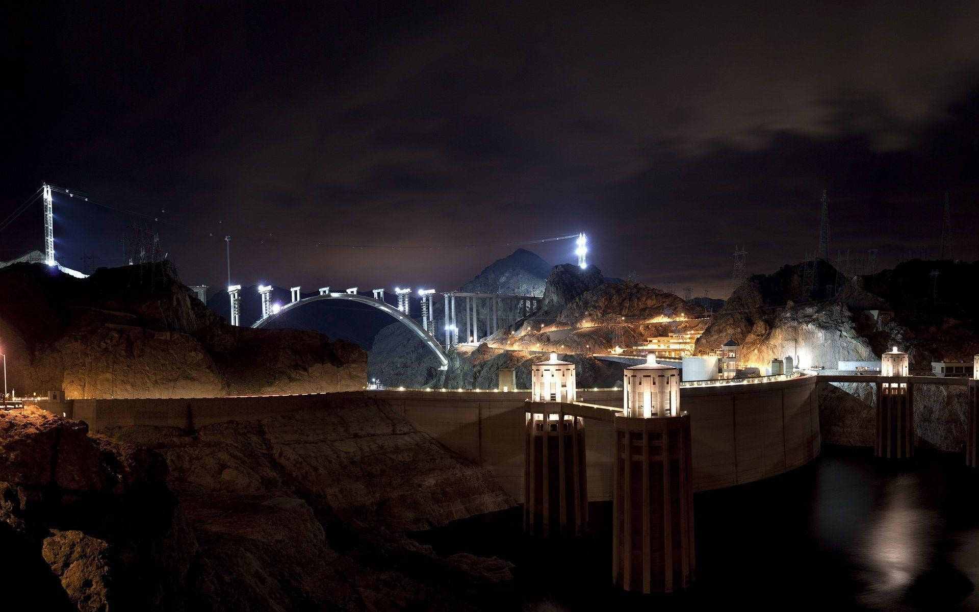 A Spellbinding View Of The Hoover Dam Illuminated At Night.