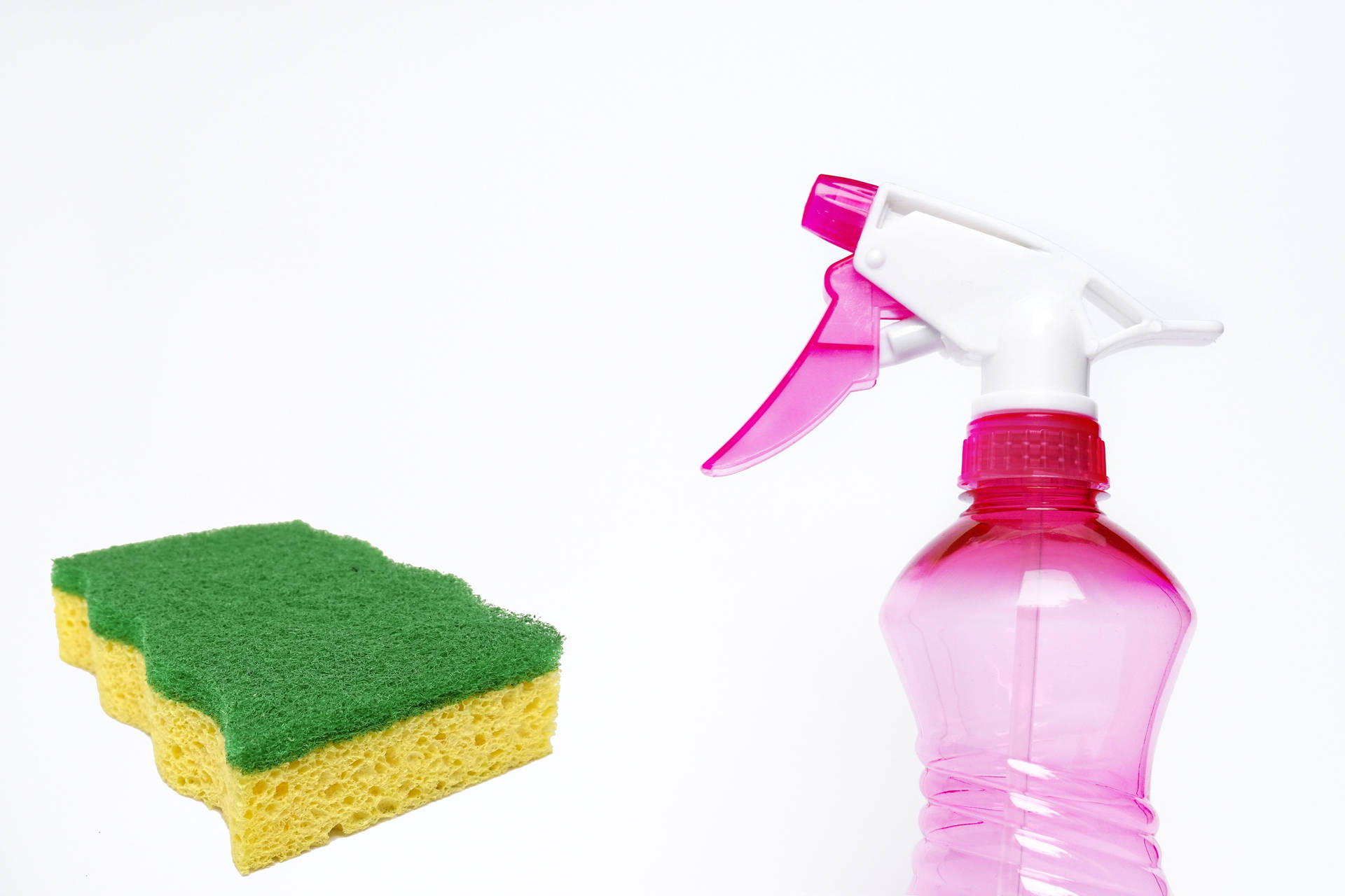 A Sponge And Spray Bottle Ready For House Cleaning Background