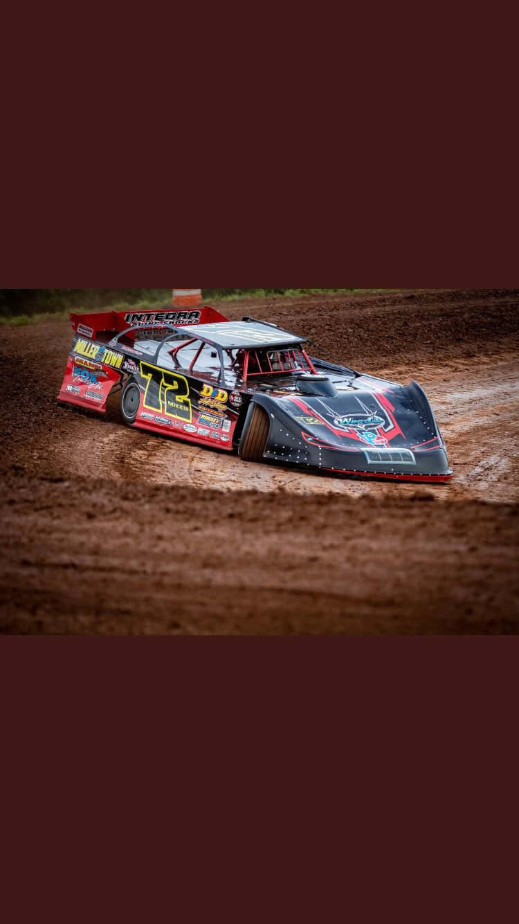 A Sprint Car Drifting Around The Track At High Speed Background