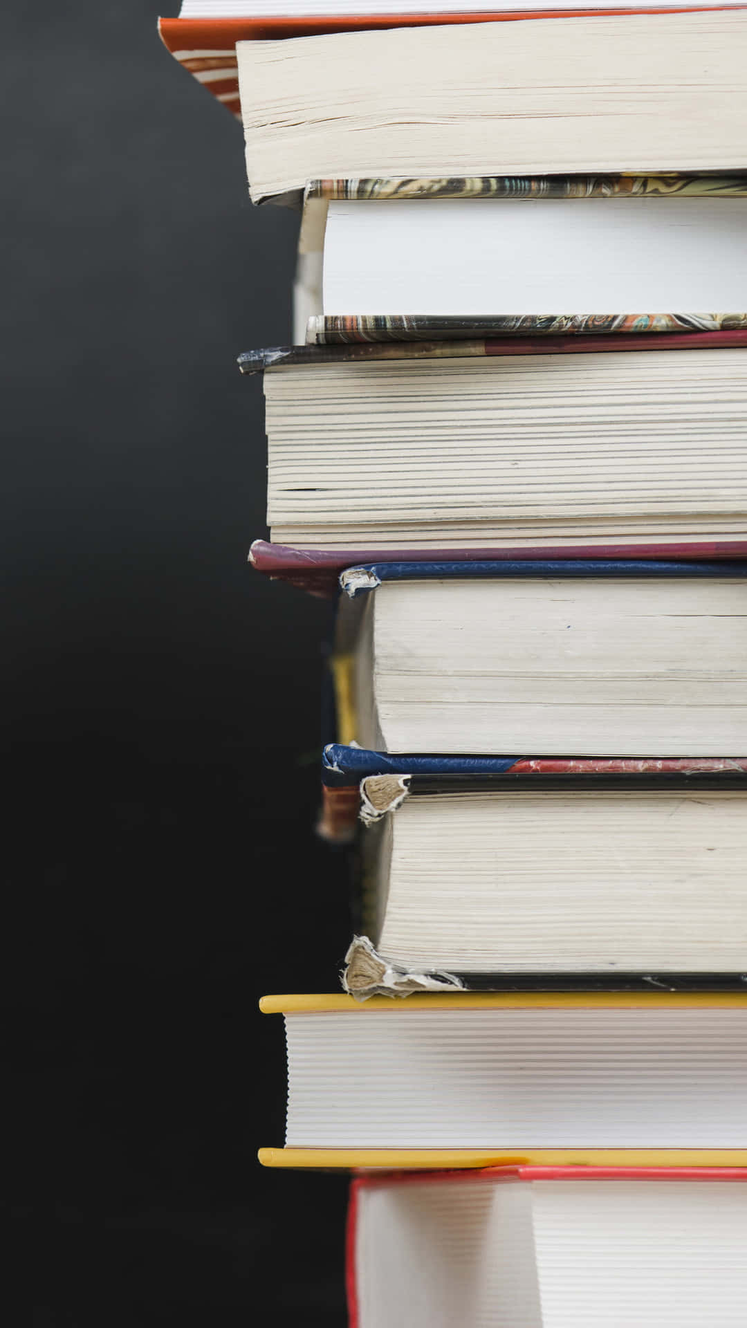 A Stack Of Books On A Black Background