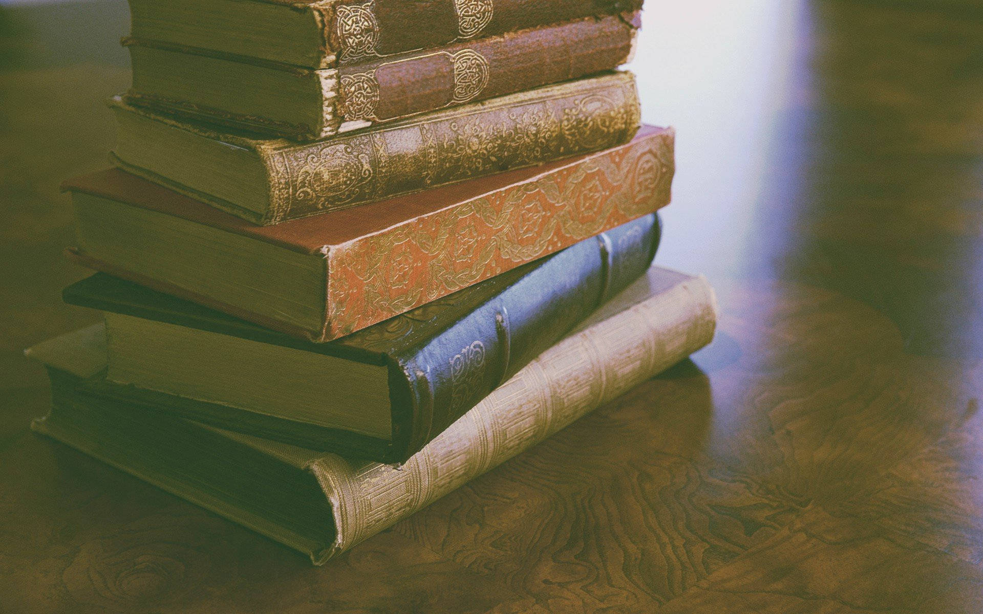 A Stack Of Books On A Table Background