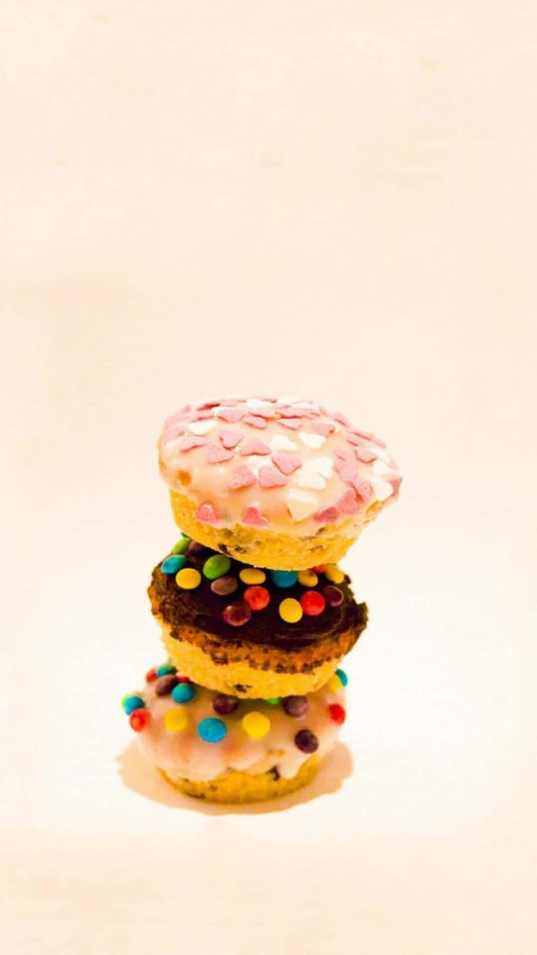 A Stack Of Donuts With Sprinkles On Top