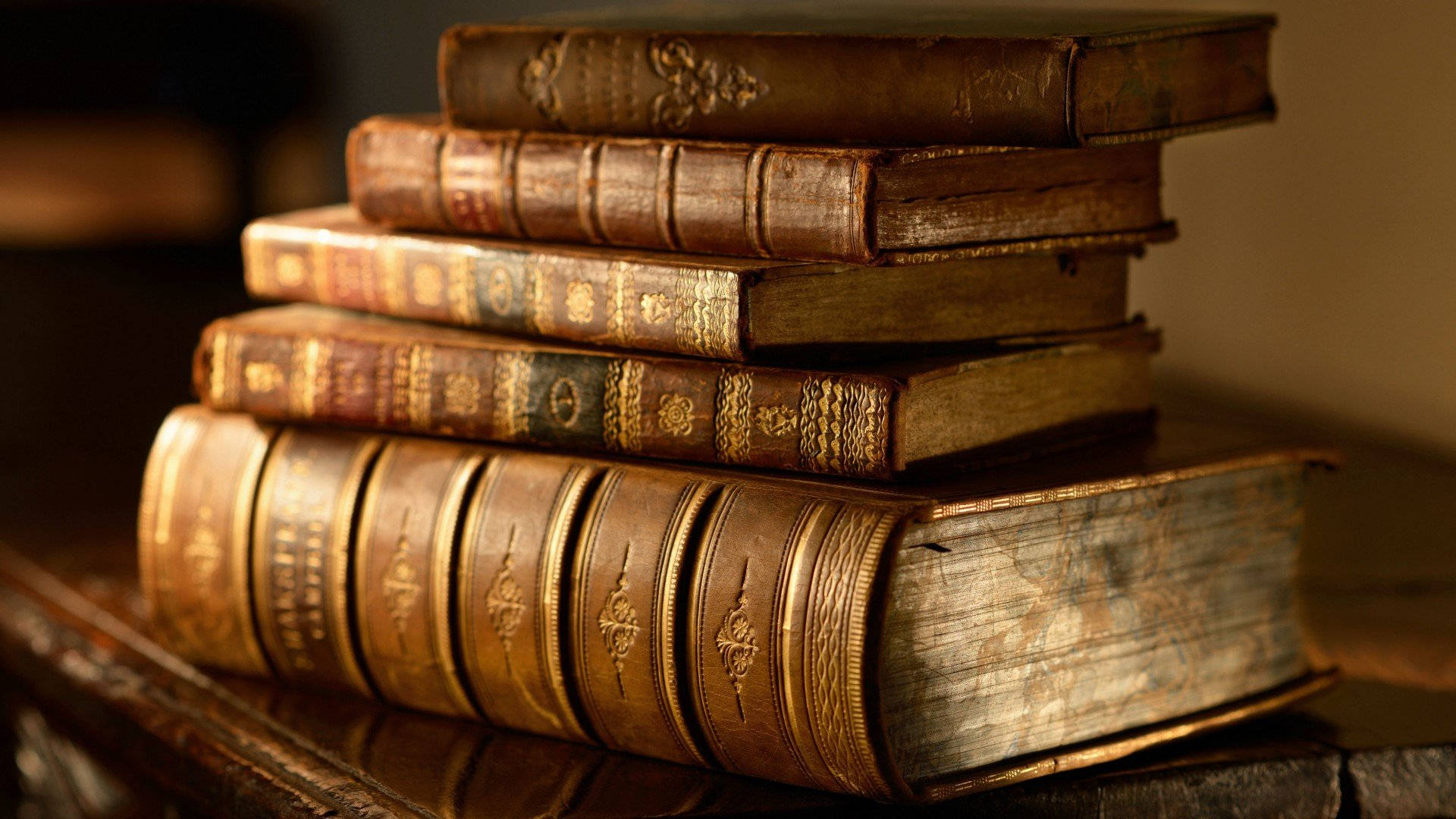 A Stack Of Old Books On A Table Background