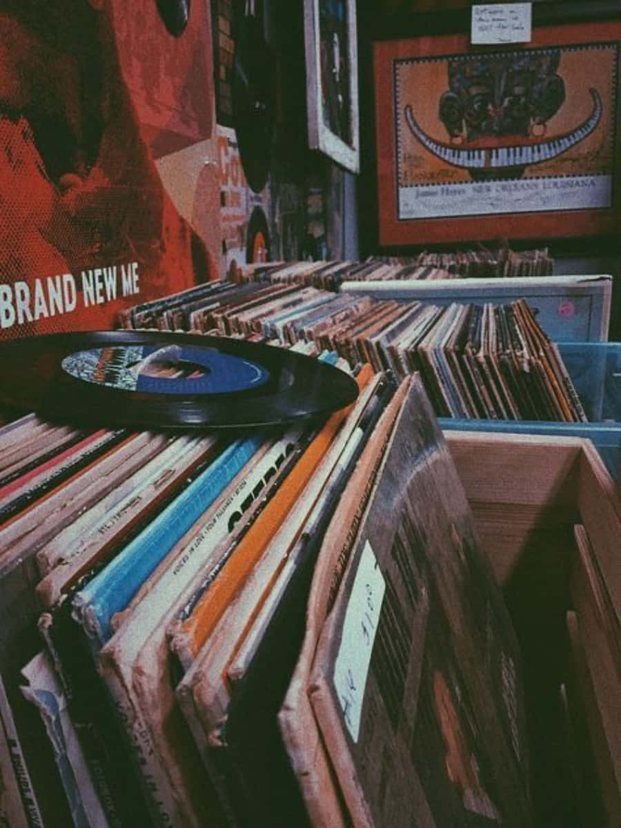 A Stack Of Records On A Shelf Background