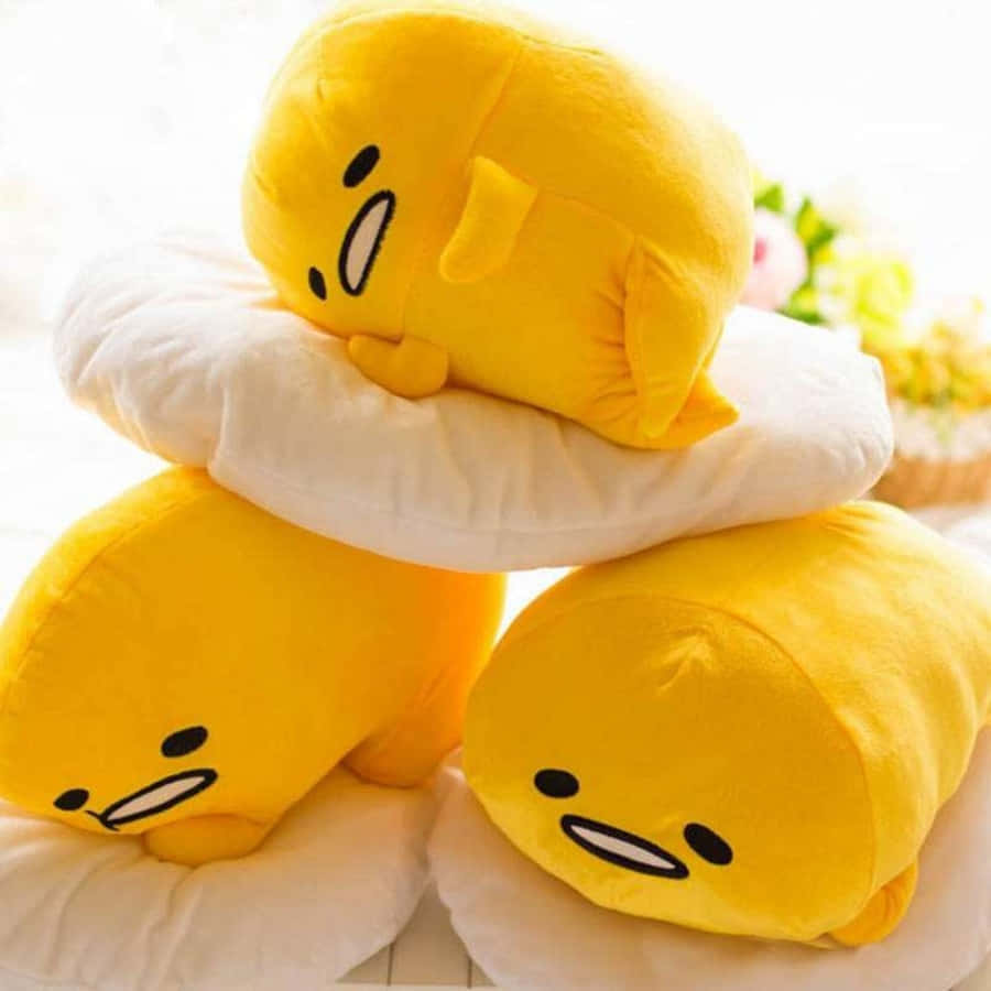 A Stack Of Yellow Stuffed Animals On Top Of Each Other Background