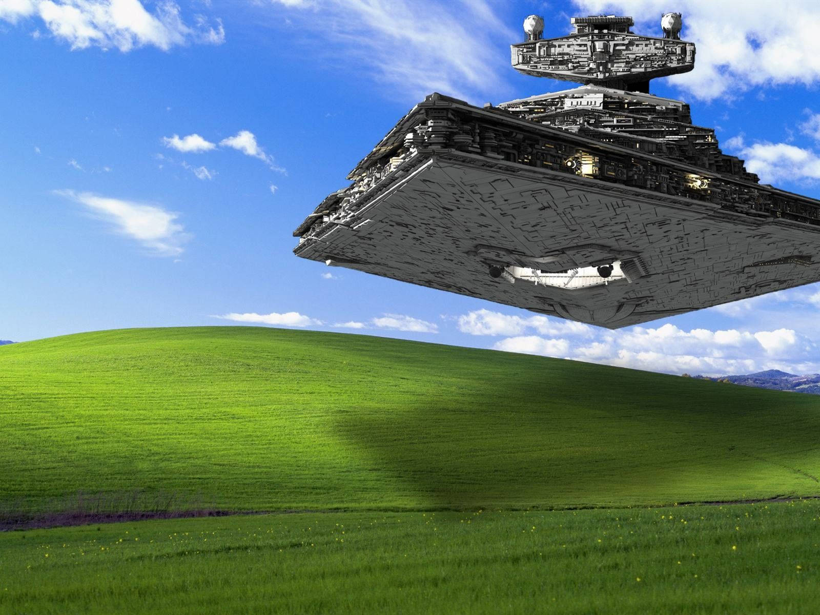 A Star Wars Ship Flying Over A Green Field Background