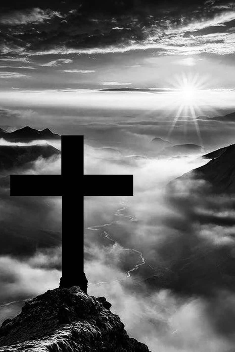 A Stark And Emotive Black Cross Set Against A White Background