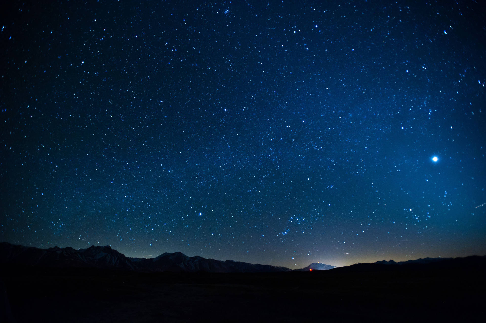 A Starry Sky With Mountains And Stars Background