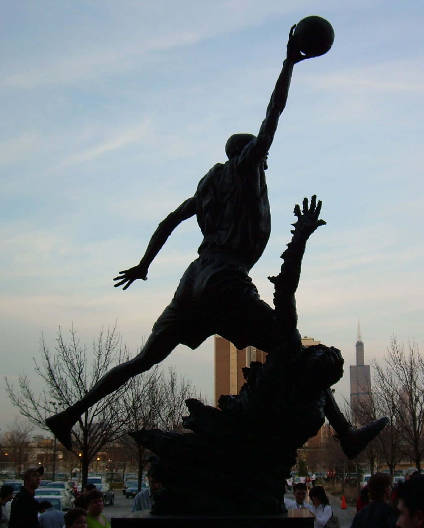 A Statue Of A Basketball Player Background