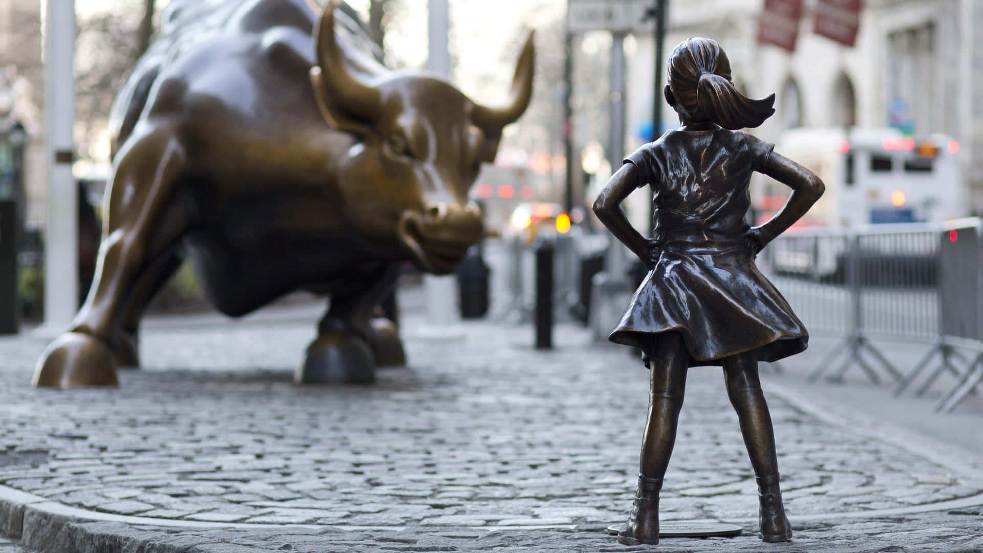 A Statue Of A Girl Standing Next To A Bull Background