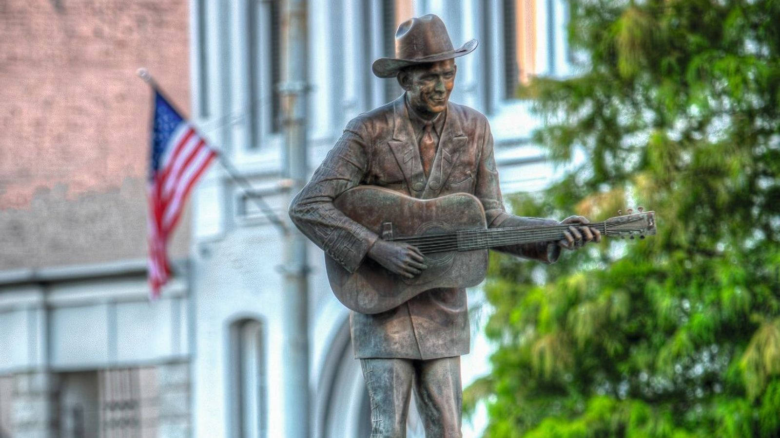 A Statue Of Hank Williams Background