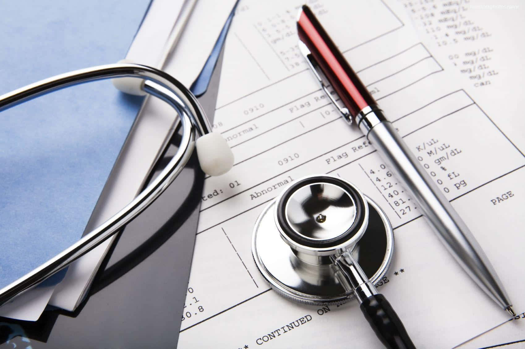 A Stethoscope And Pen On Top Of Medical Papers Background