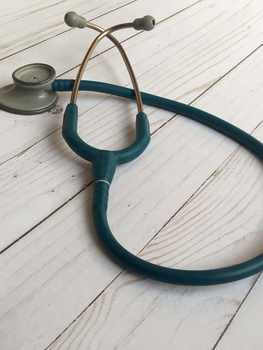 A Stethoscope On A Wooden Table Background