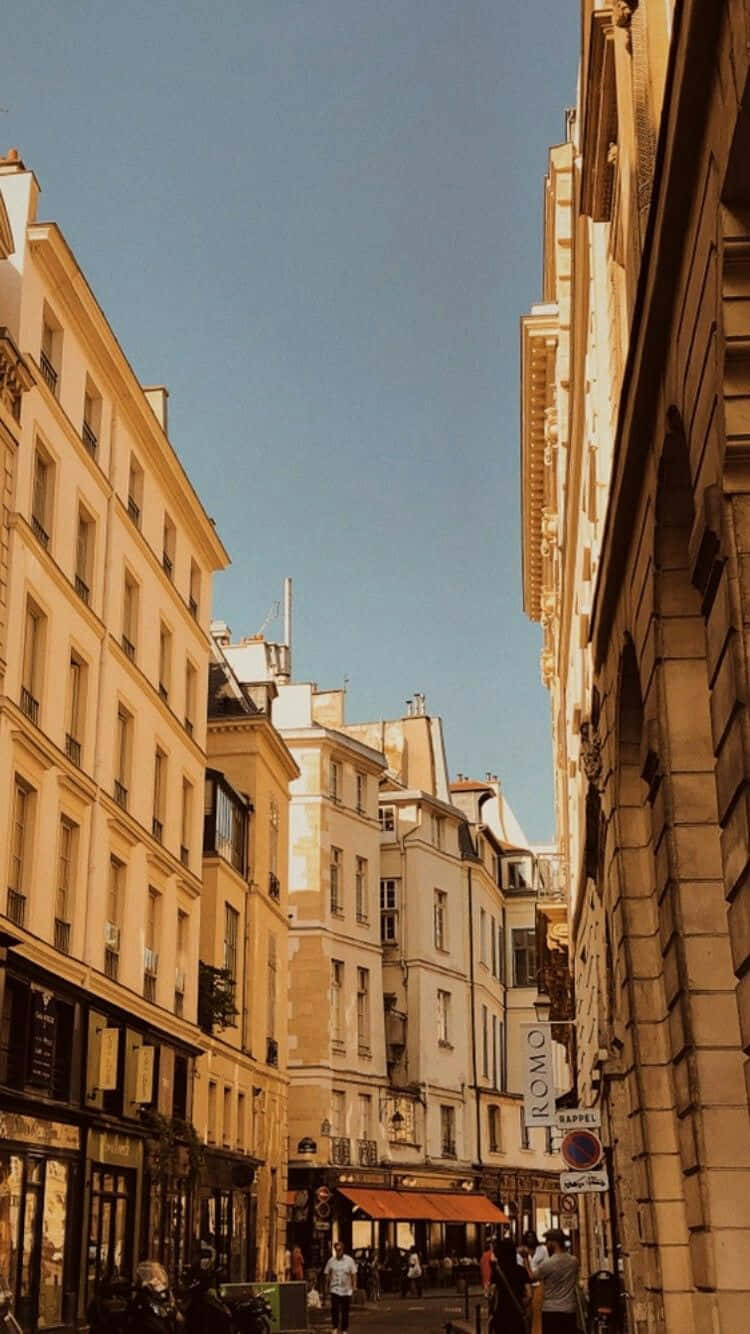 A Street In Paris With Many Buildings And People Background