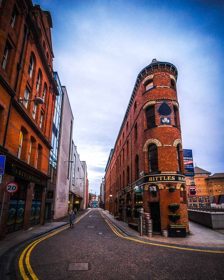 A Street With A Red Brick Building And A Clock Tower