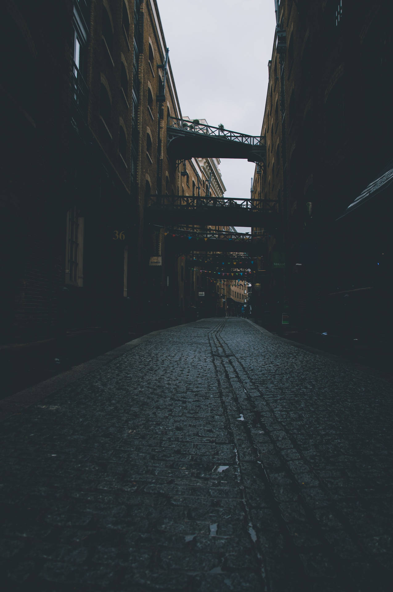 A Street With A Train Going Down It Background