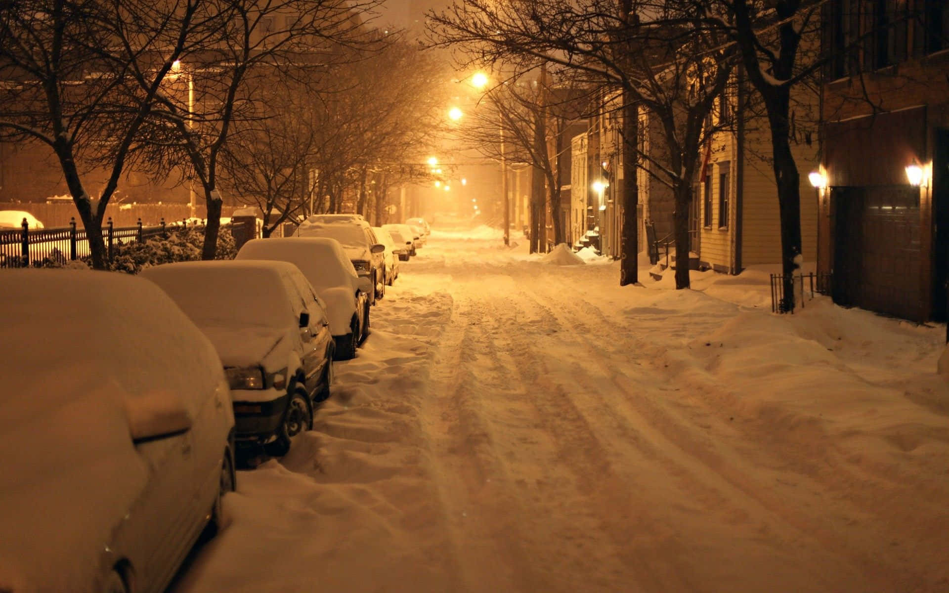 A Street With Cars Parked In The Snow Background