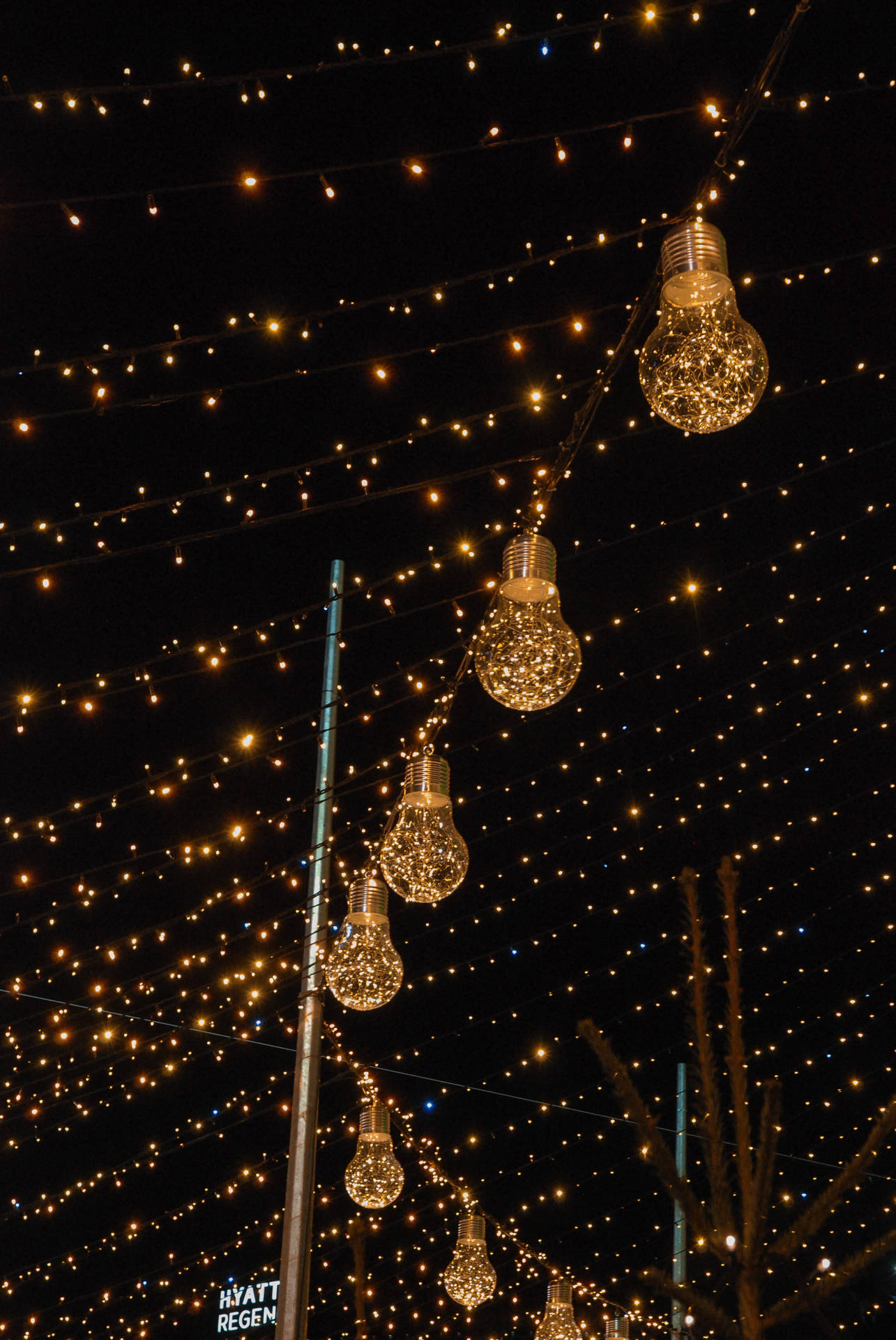 A Street With Lights And A Christmas Tree Background