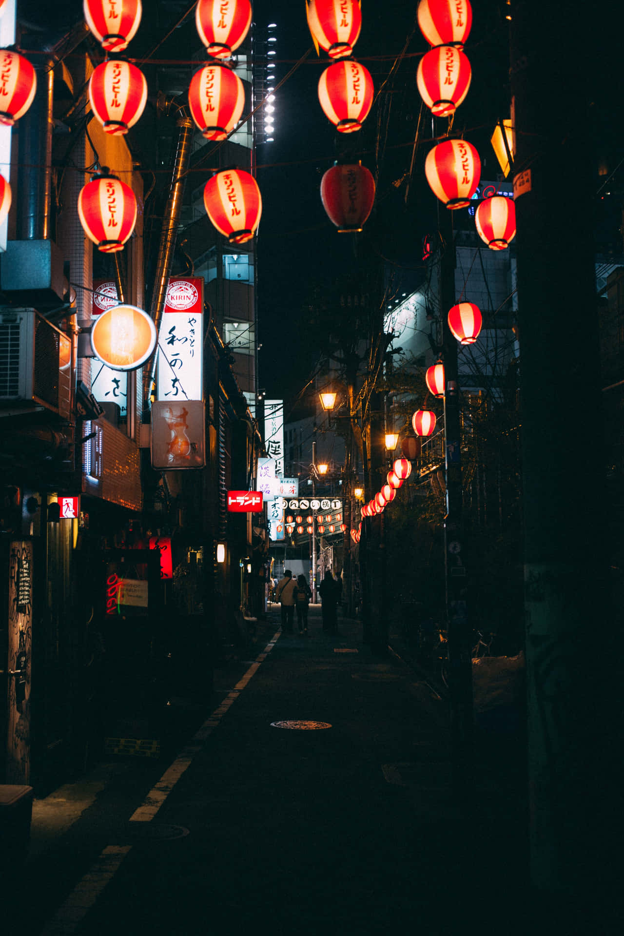 A Street With Many Lanterns Hanging From The Ceiling Background