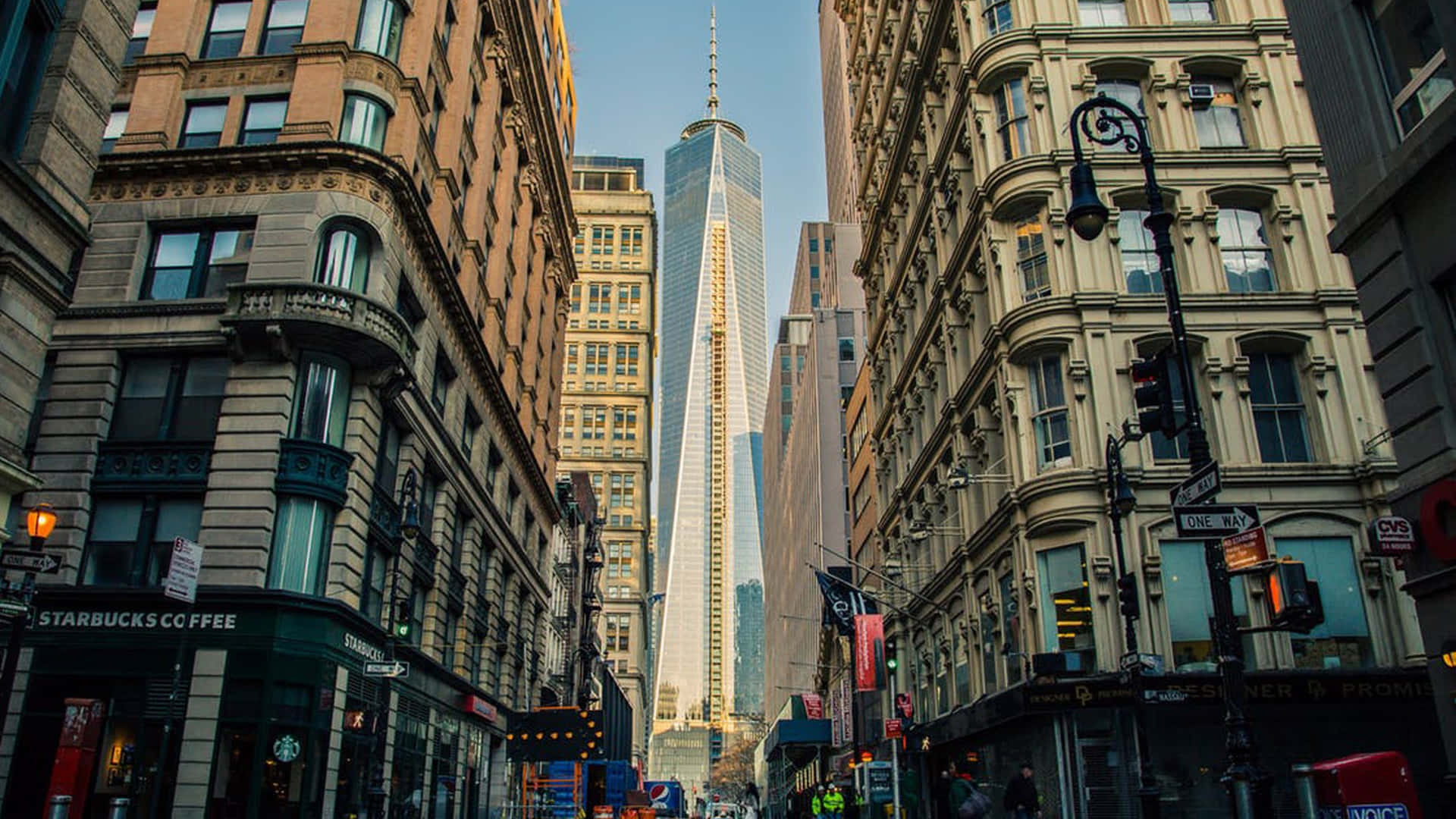 A Street With Tall Buildings And A Tall Building Background