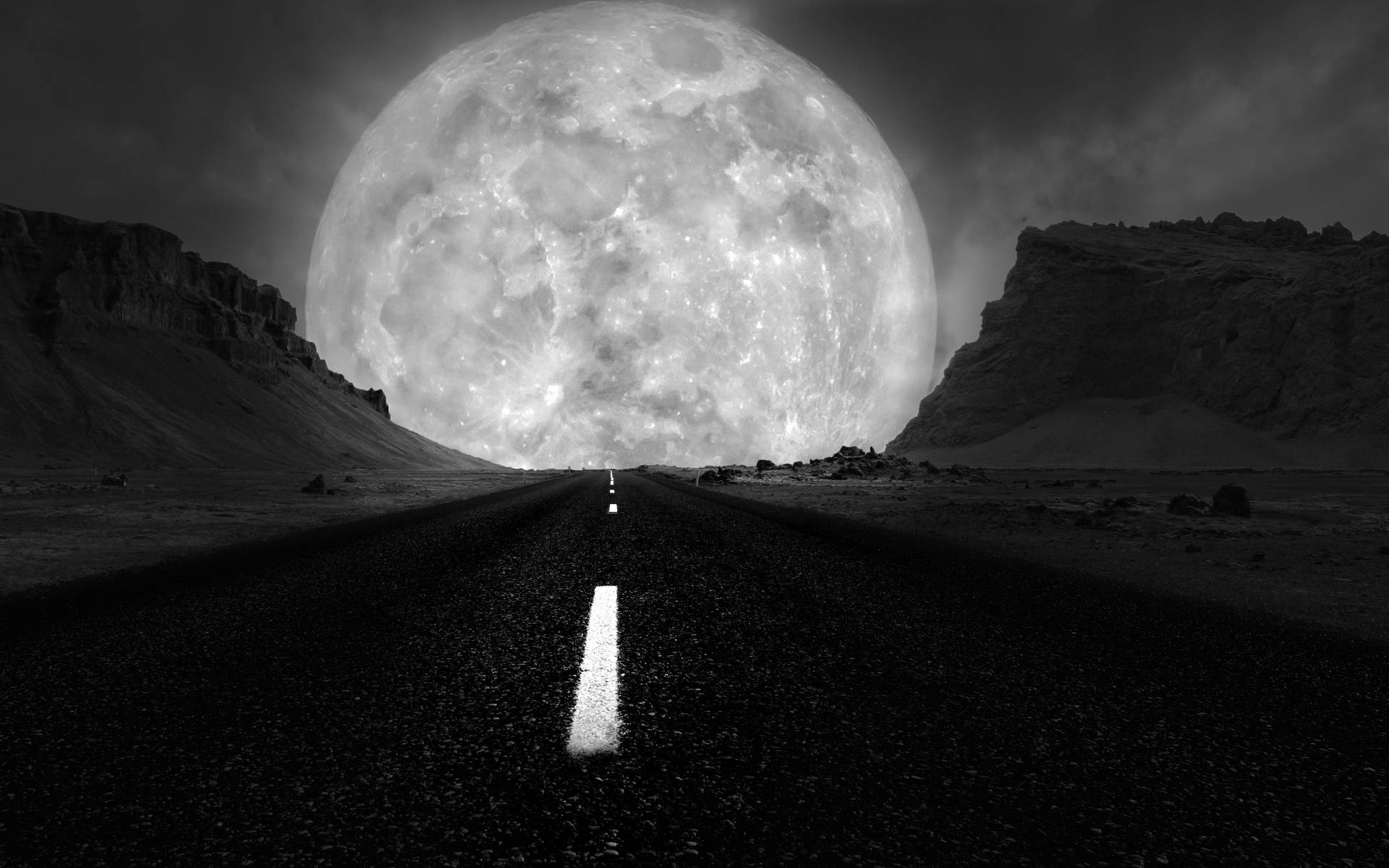 A Striking Image Of The Grayscale Galaxy Moon Over A Lonely Road