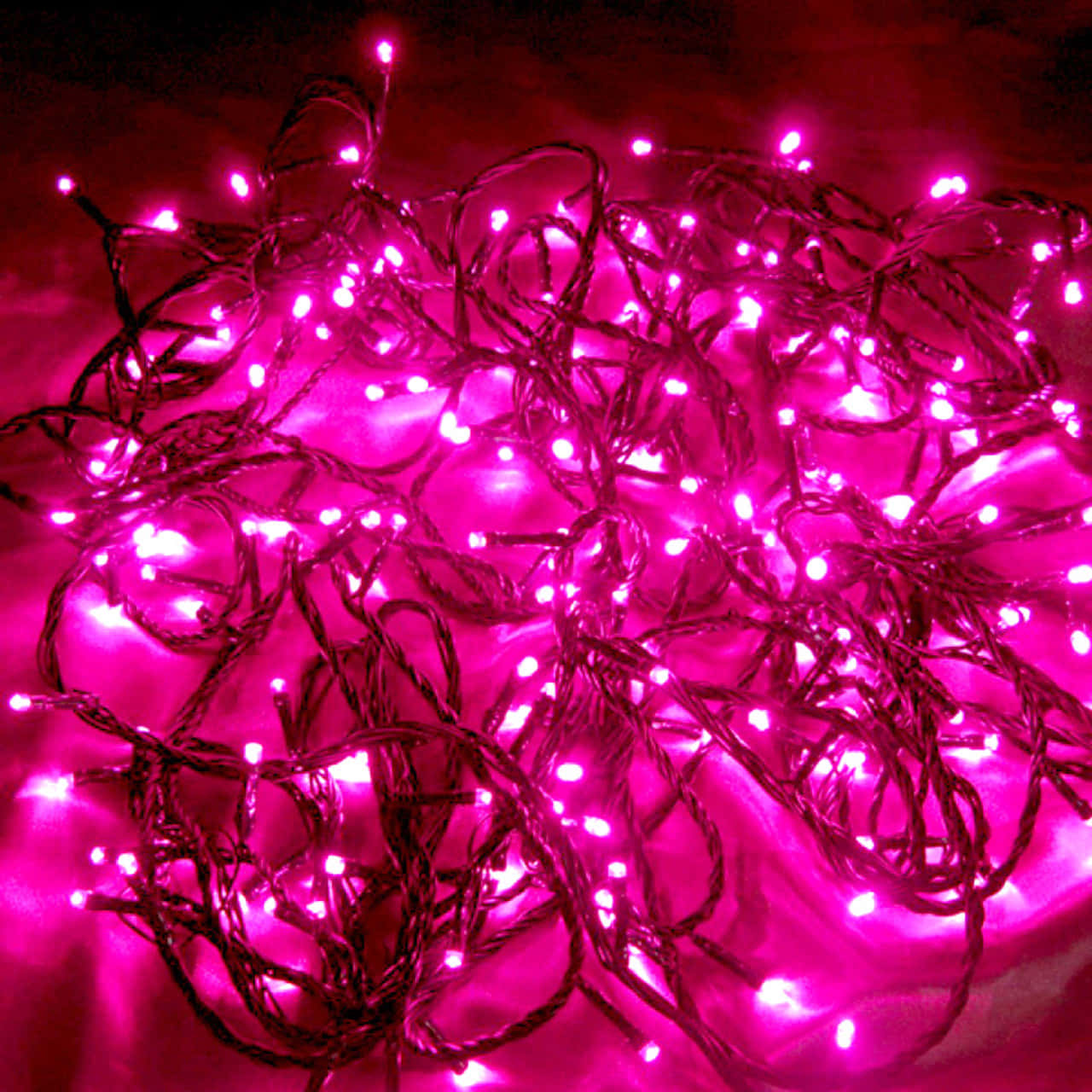 A String Of Pink Fairy Lights Draped Across A Room Creates A Magical, Warm Ambience. Background