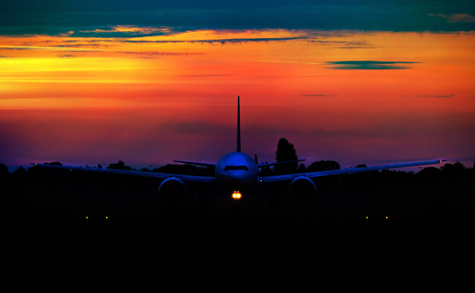 A Stunning Aerial View Of The Sun Setting Below An Airplane Background