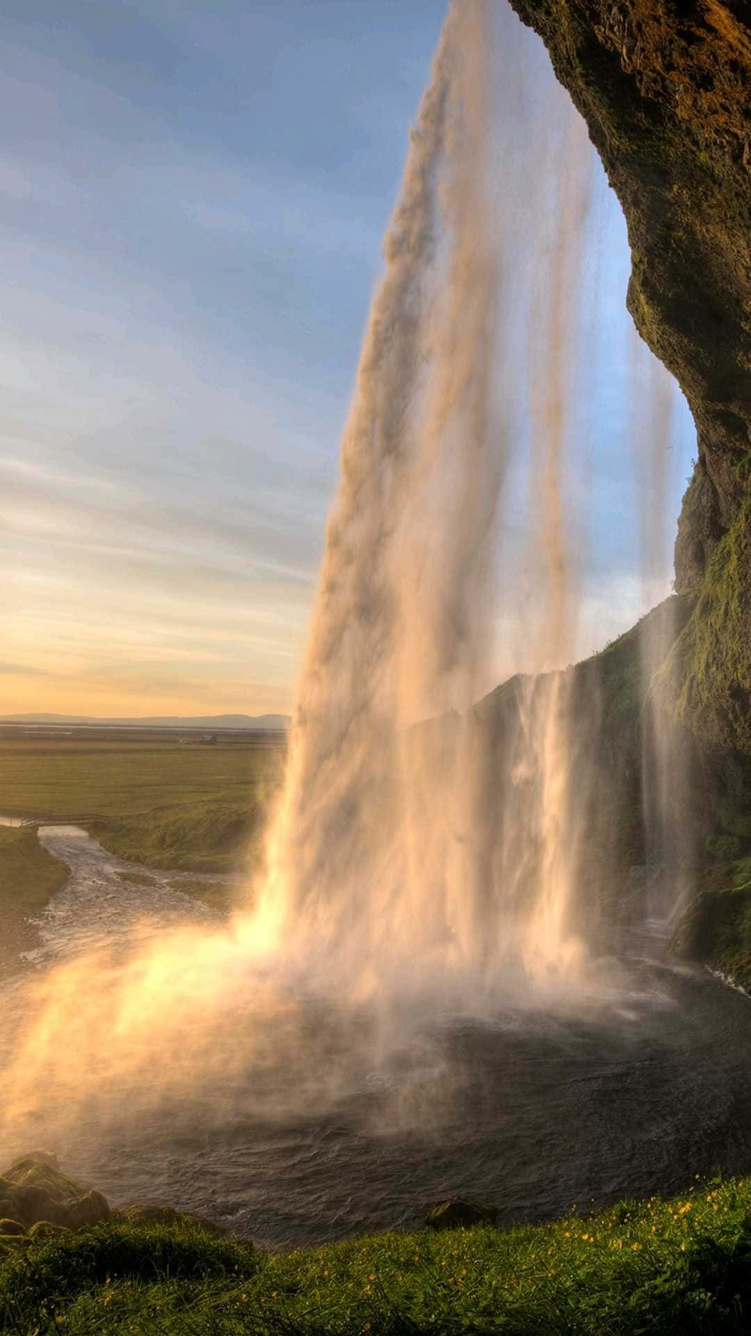 A Stunning View Of An Iphone By A Beautiful Waterfall.