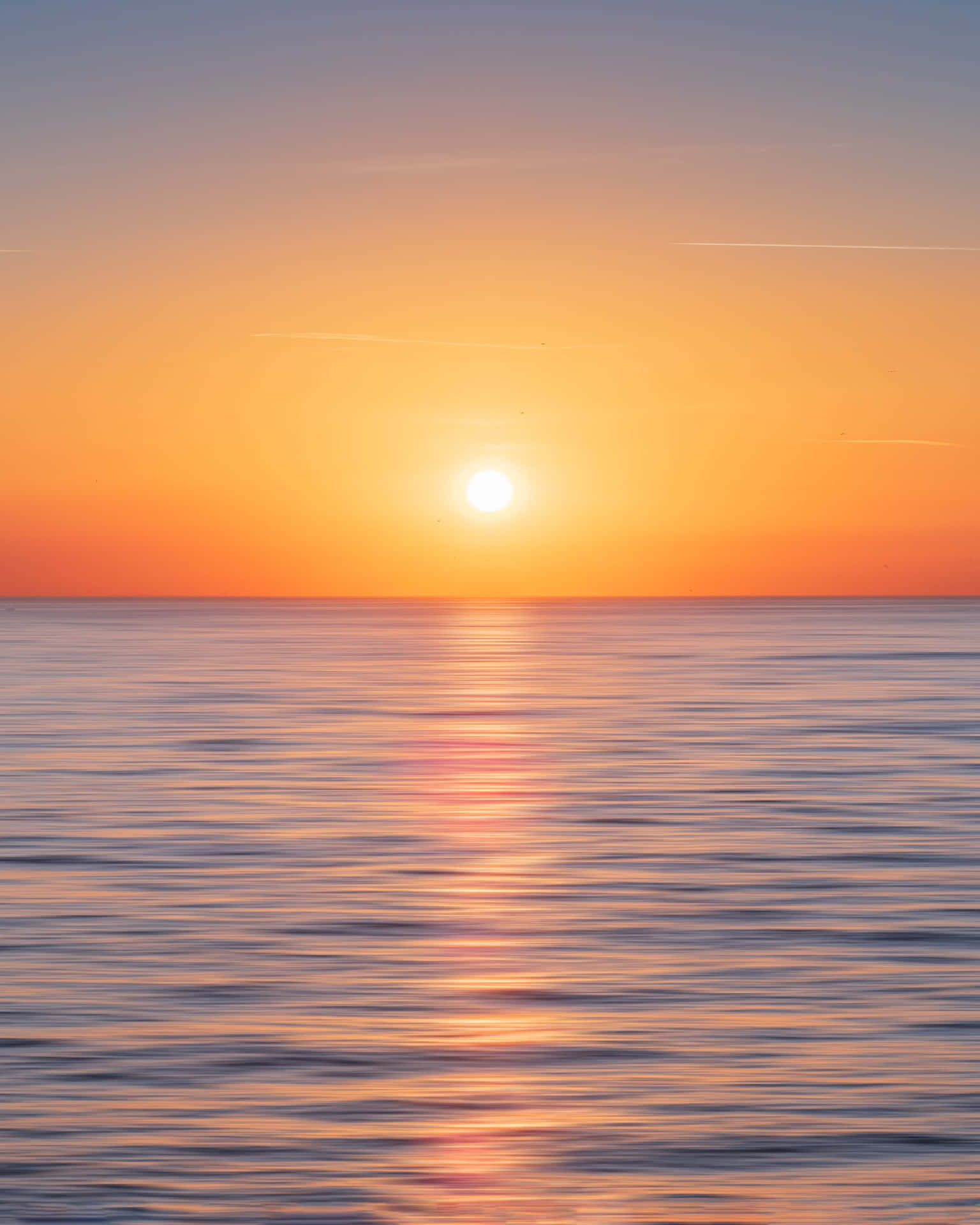 A Stunningly Beautiful Sunset Over The Calm And Inviting Ocean.