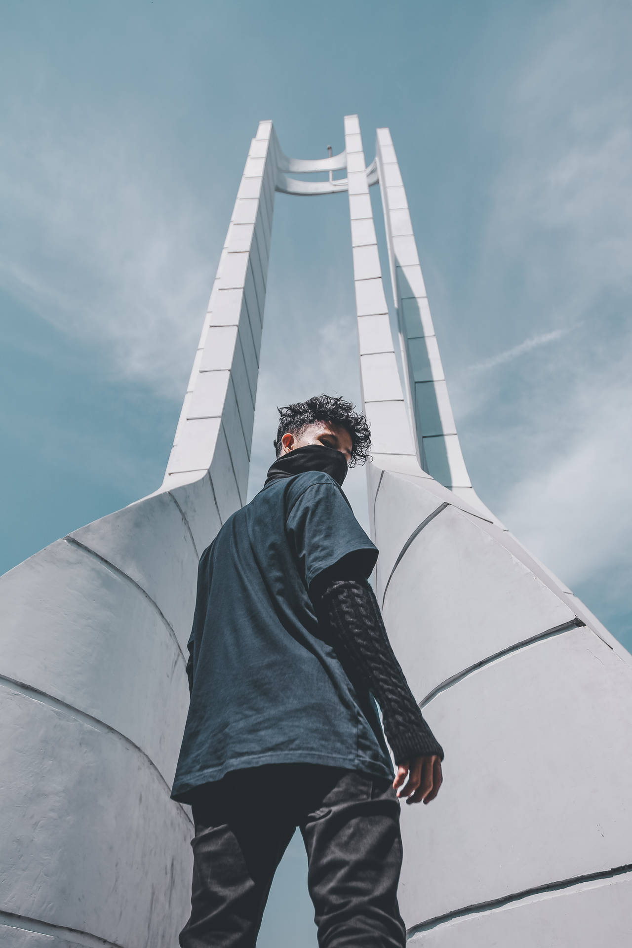 A Stylish Young Man Clad In Black Looking Into The Distance. Background