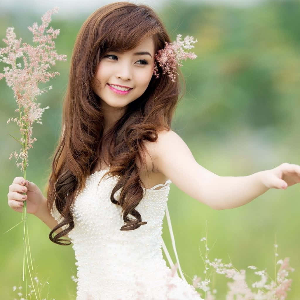 A Stylish Young Woman Using An Ipad In A Modern Cityscape Background