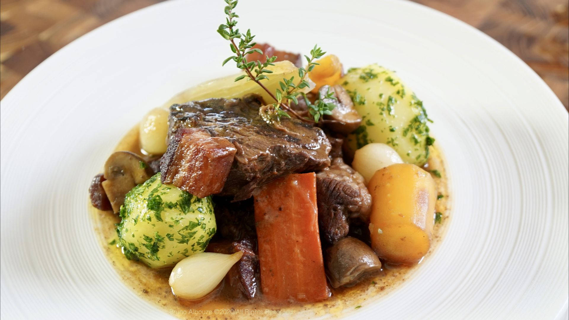 A Sumptuous Serving Of Beef Bourguignon Garnished Beautifully. Background