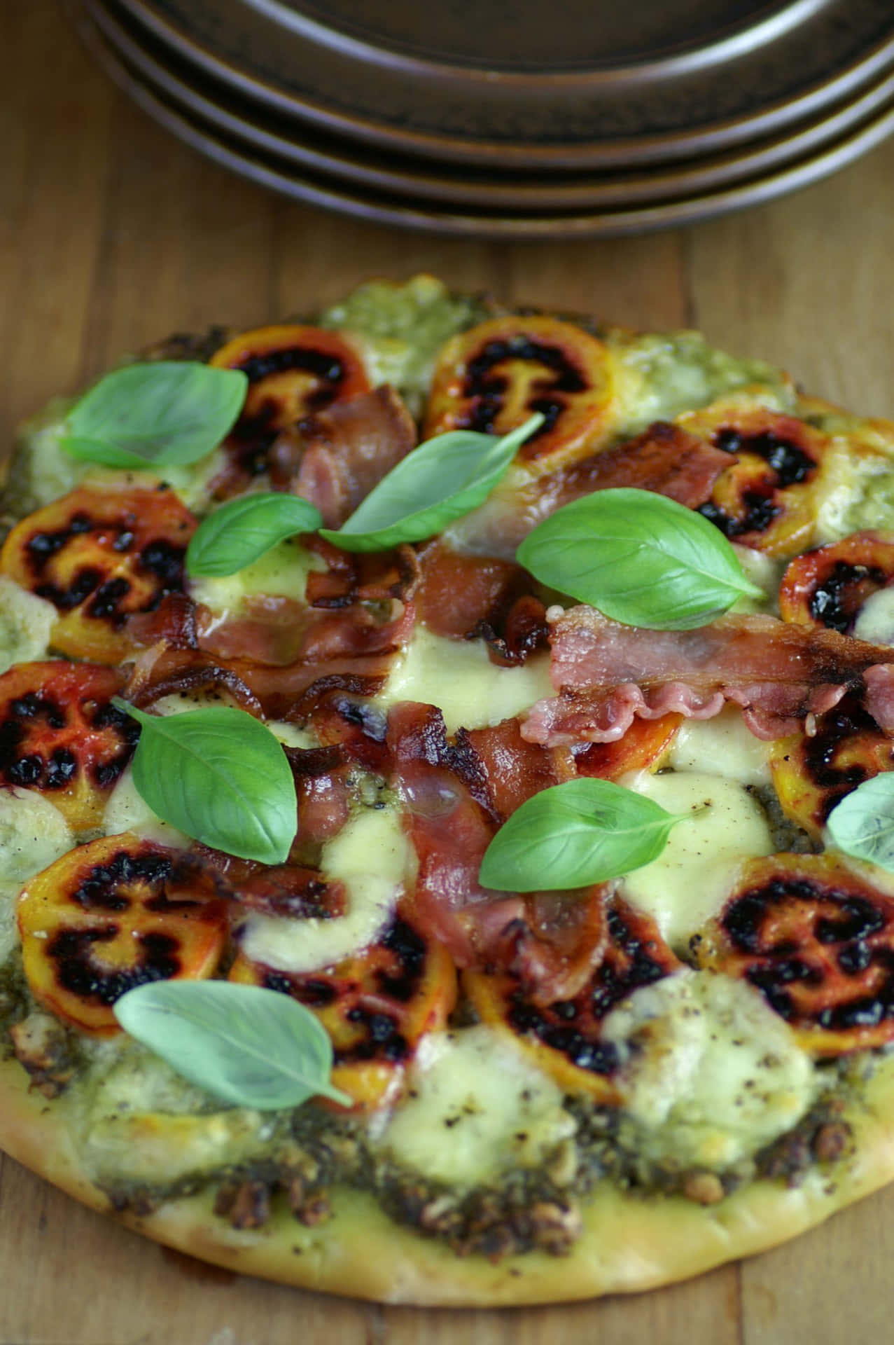 A Sumptuous Tamarillo Pizza Garnished With Fresh Basil Leaves Background