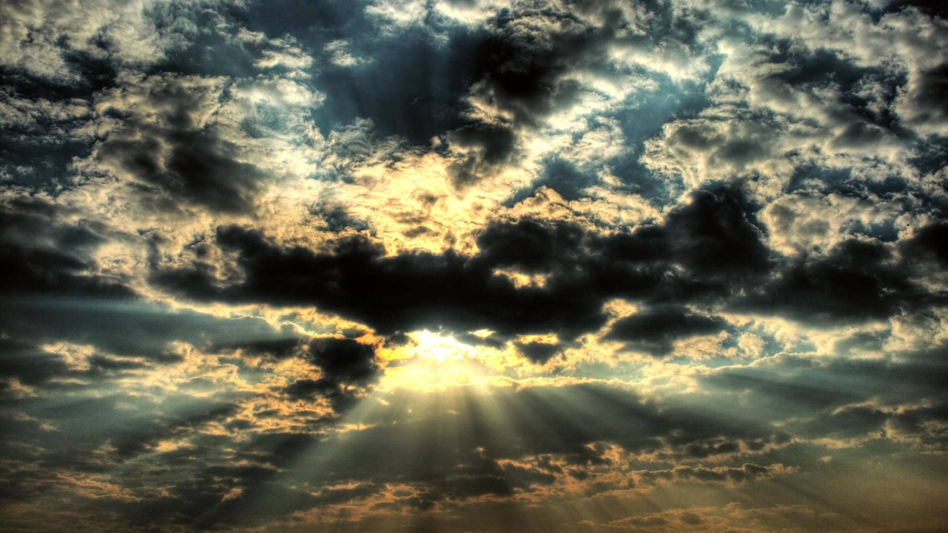 A Sunbeam Shining Through The Clouds Background