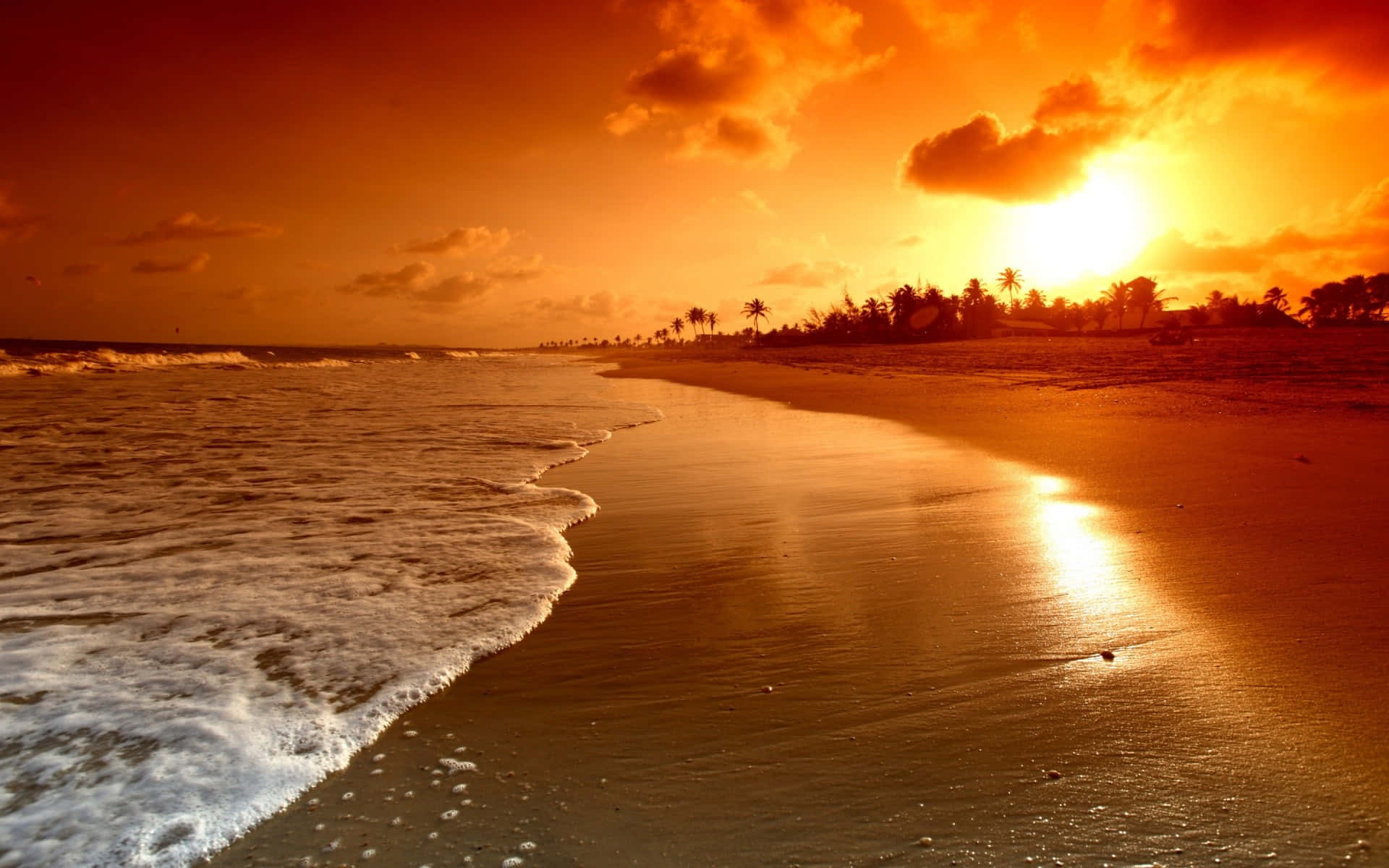 A Sunset On A Beach With Waves Background