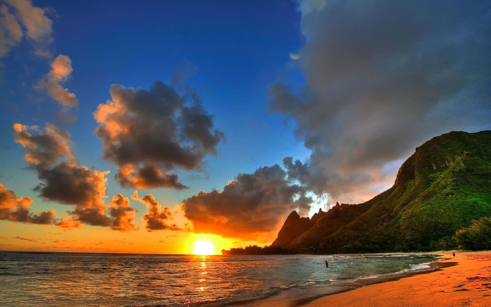A Sunset Over A Beach With Mountains In The Background Background