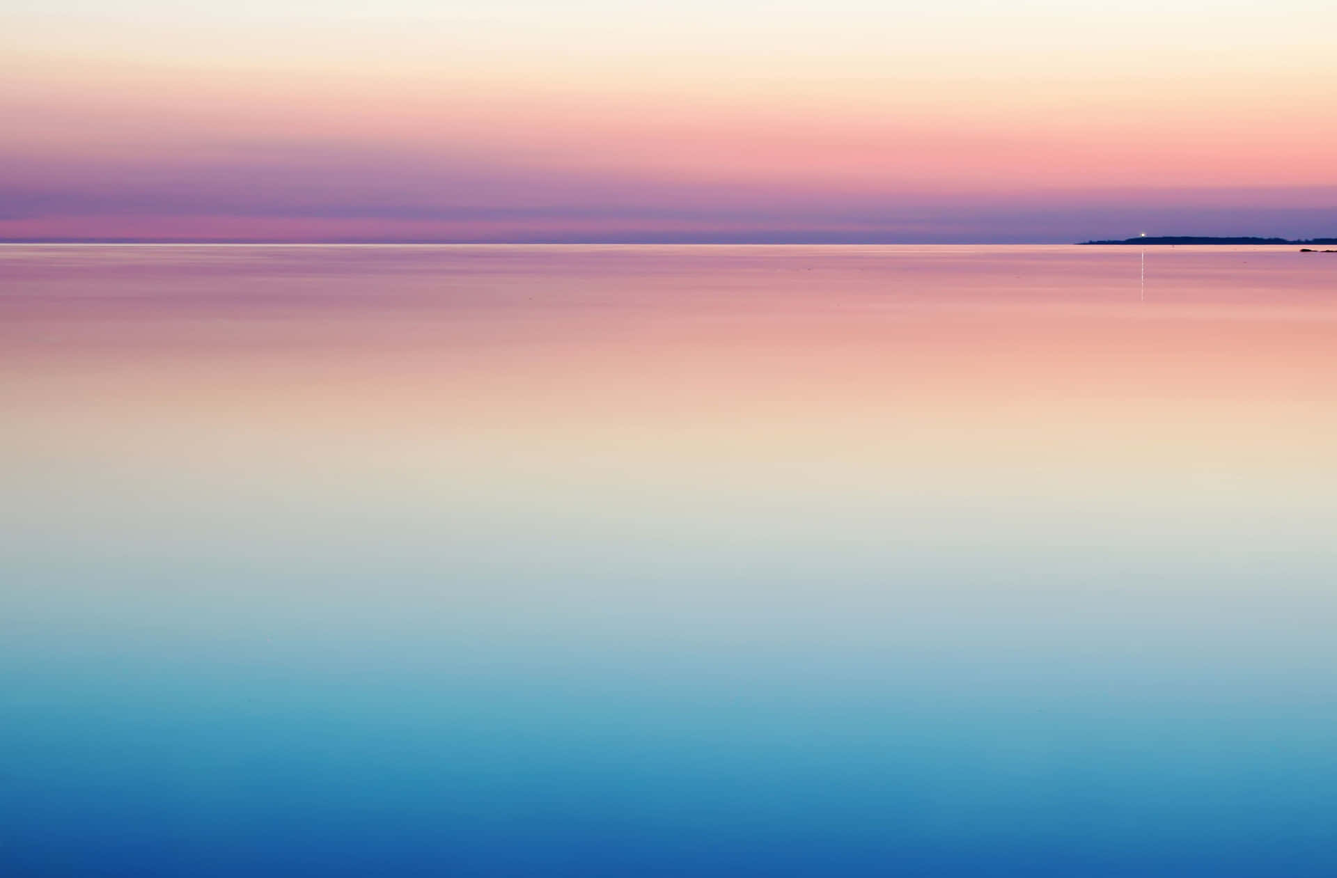 A Sunset Over A Calm Body Of Water Background