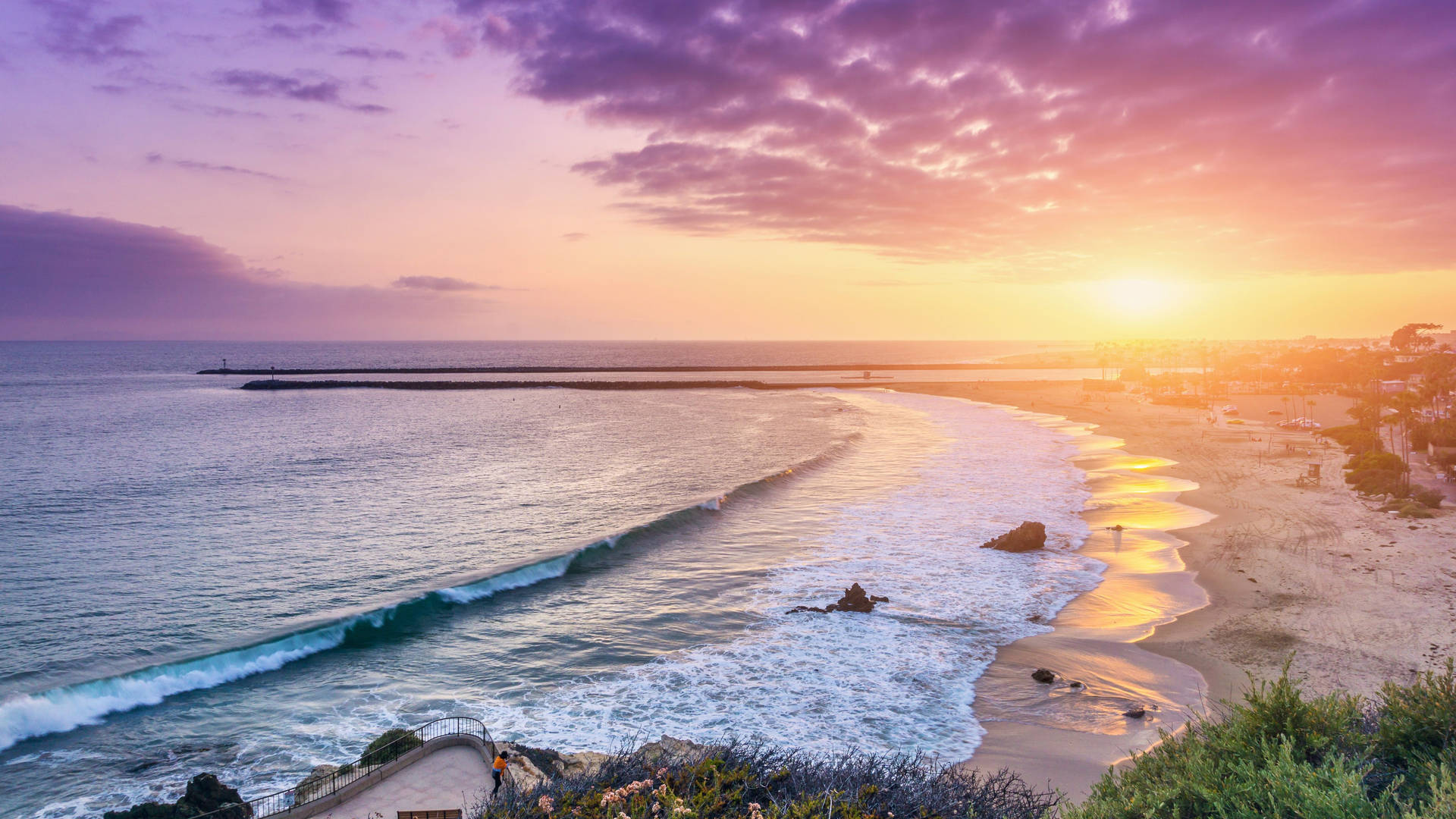 A Sunset Over The Ocean At A Beach