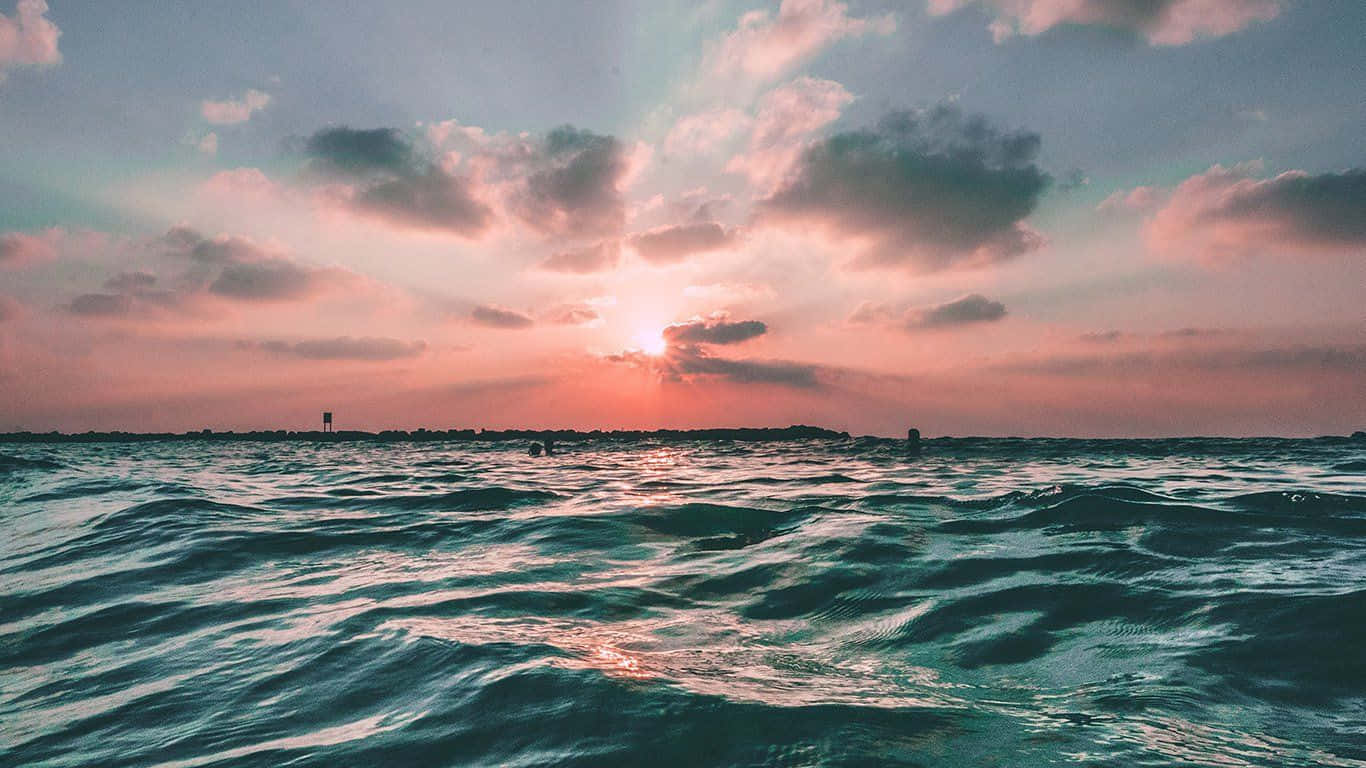 A Sunset Over The Ocean Background