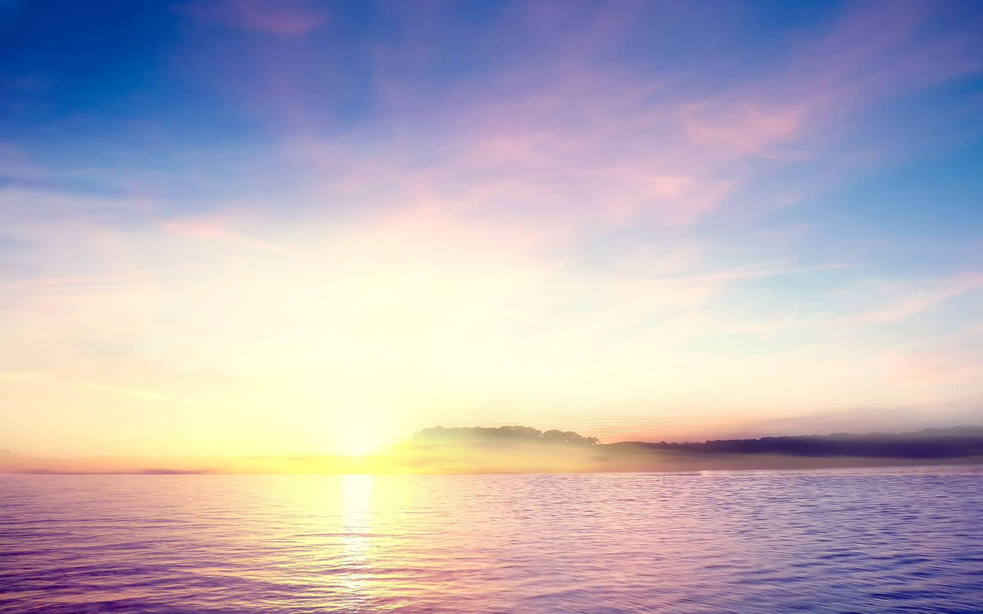 A Sunset Over The Ocean With Clouds And Mountains