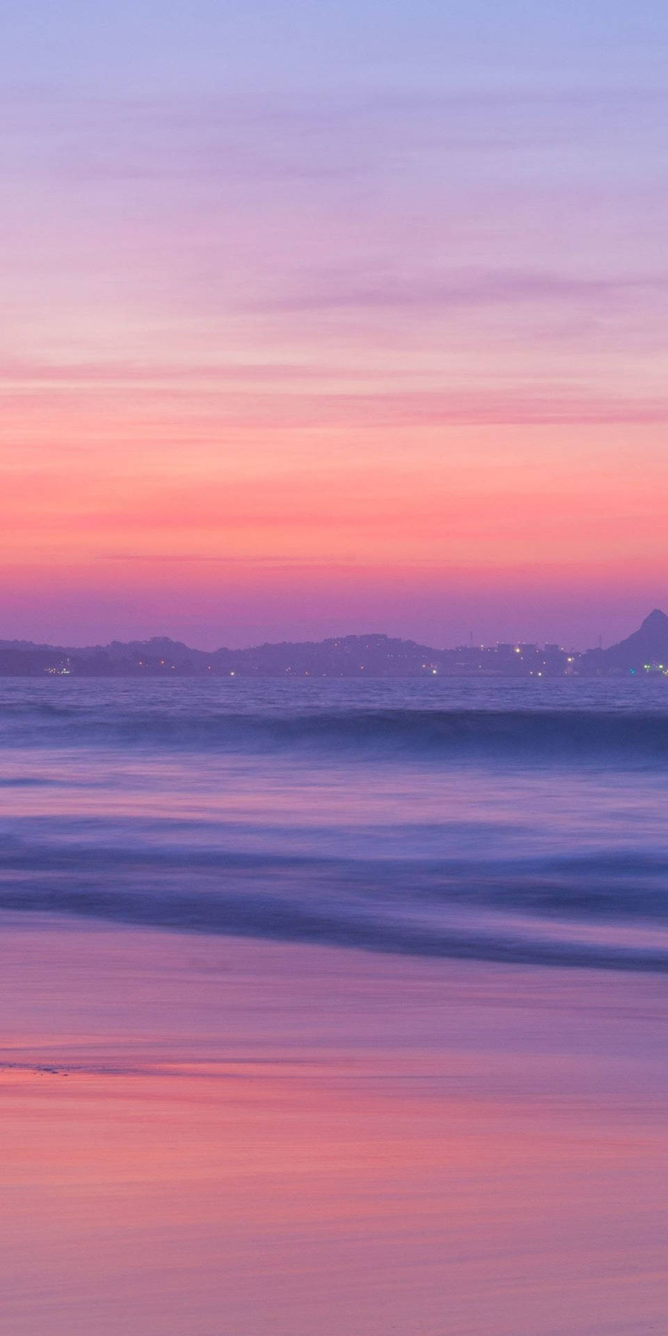 A Sunset With A Pink Sky And Water Background