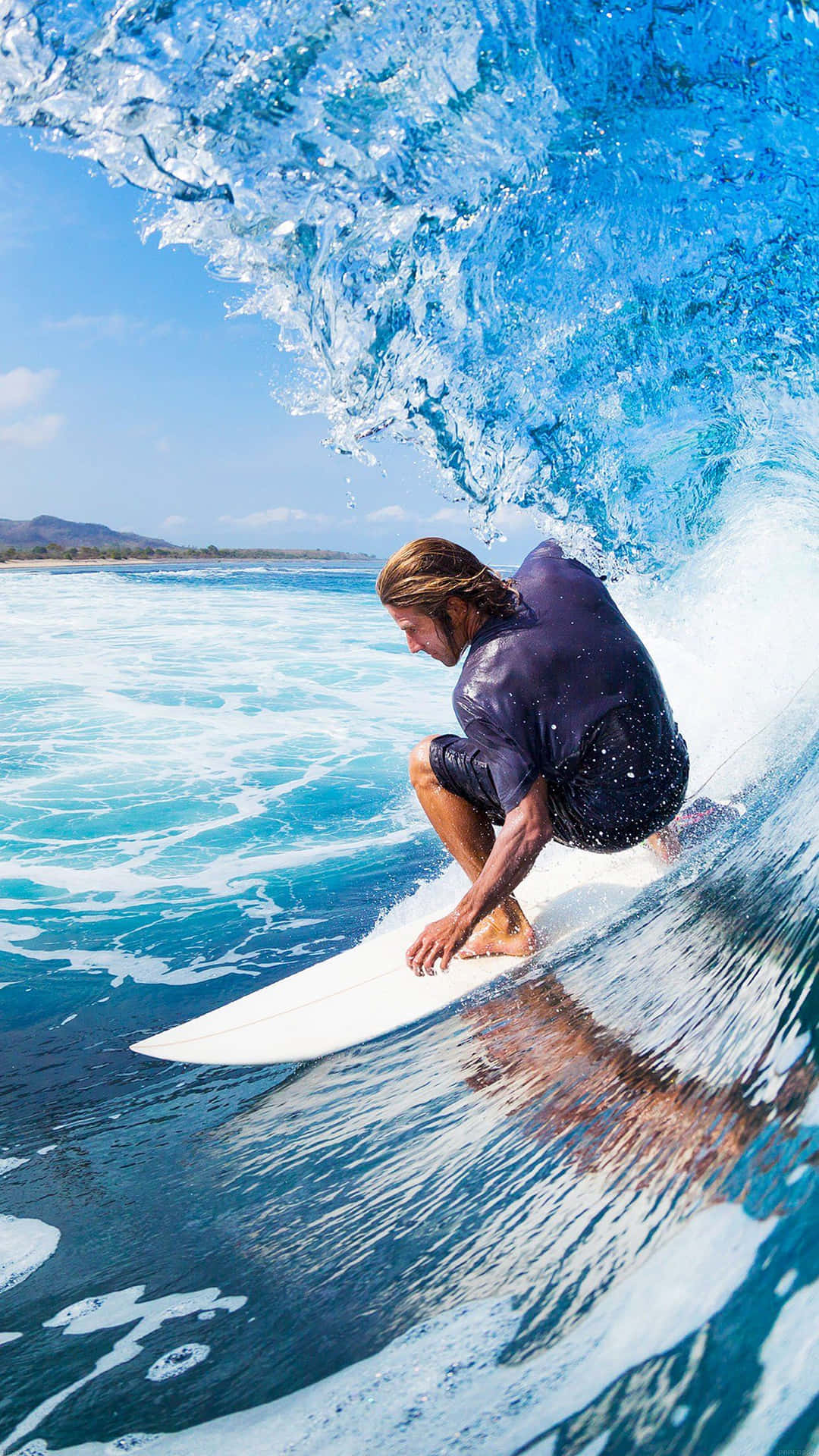 A Surfer Riding A Wave Background