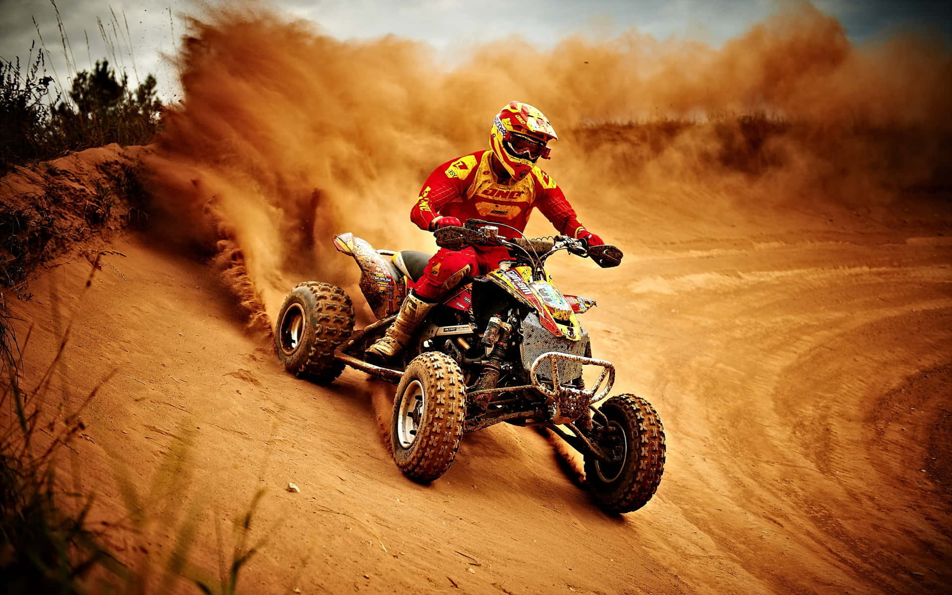 A T V Racer Kicking Up Dust Background