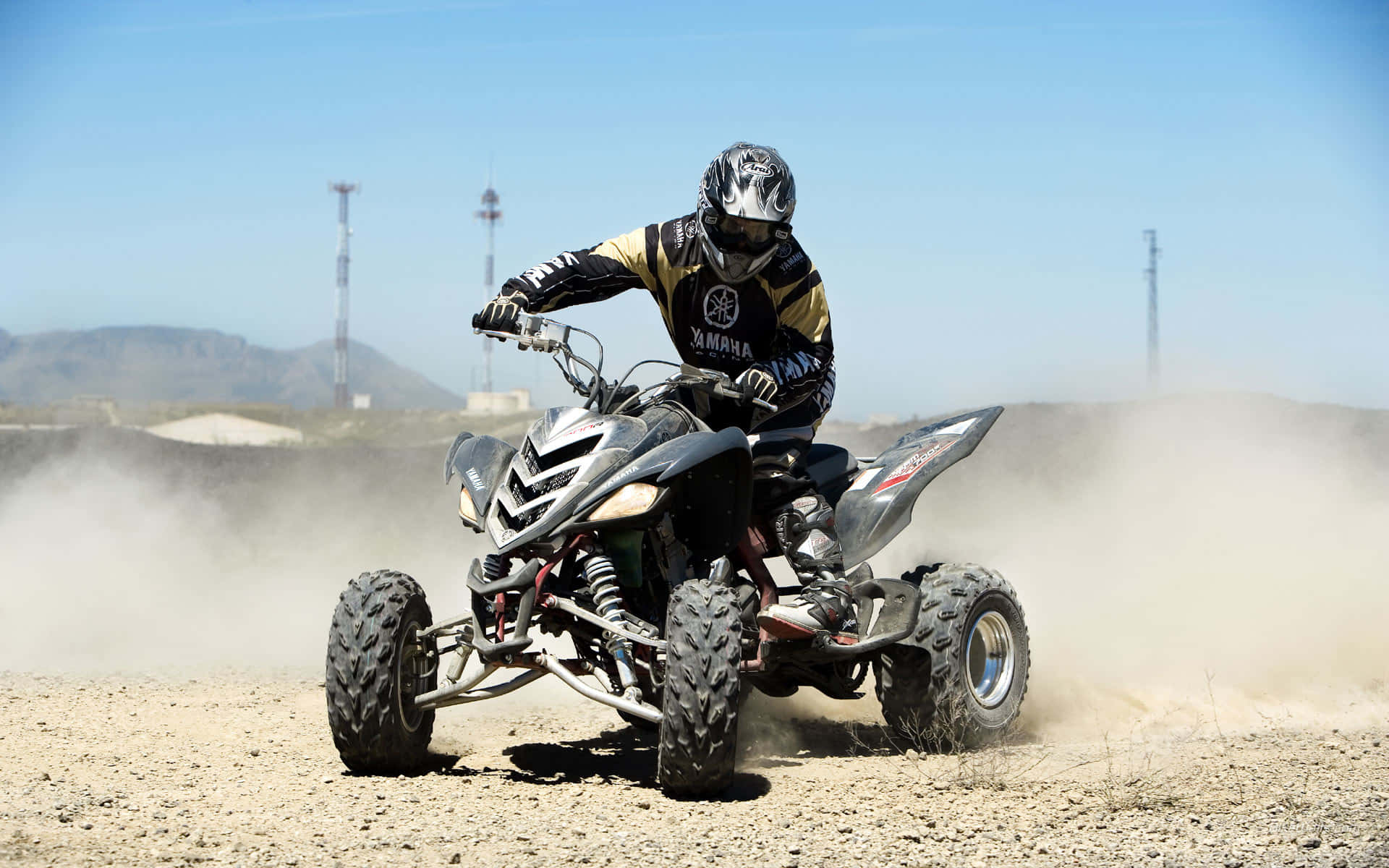 A T V Rider Kicking Up Dust Background