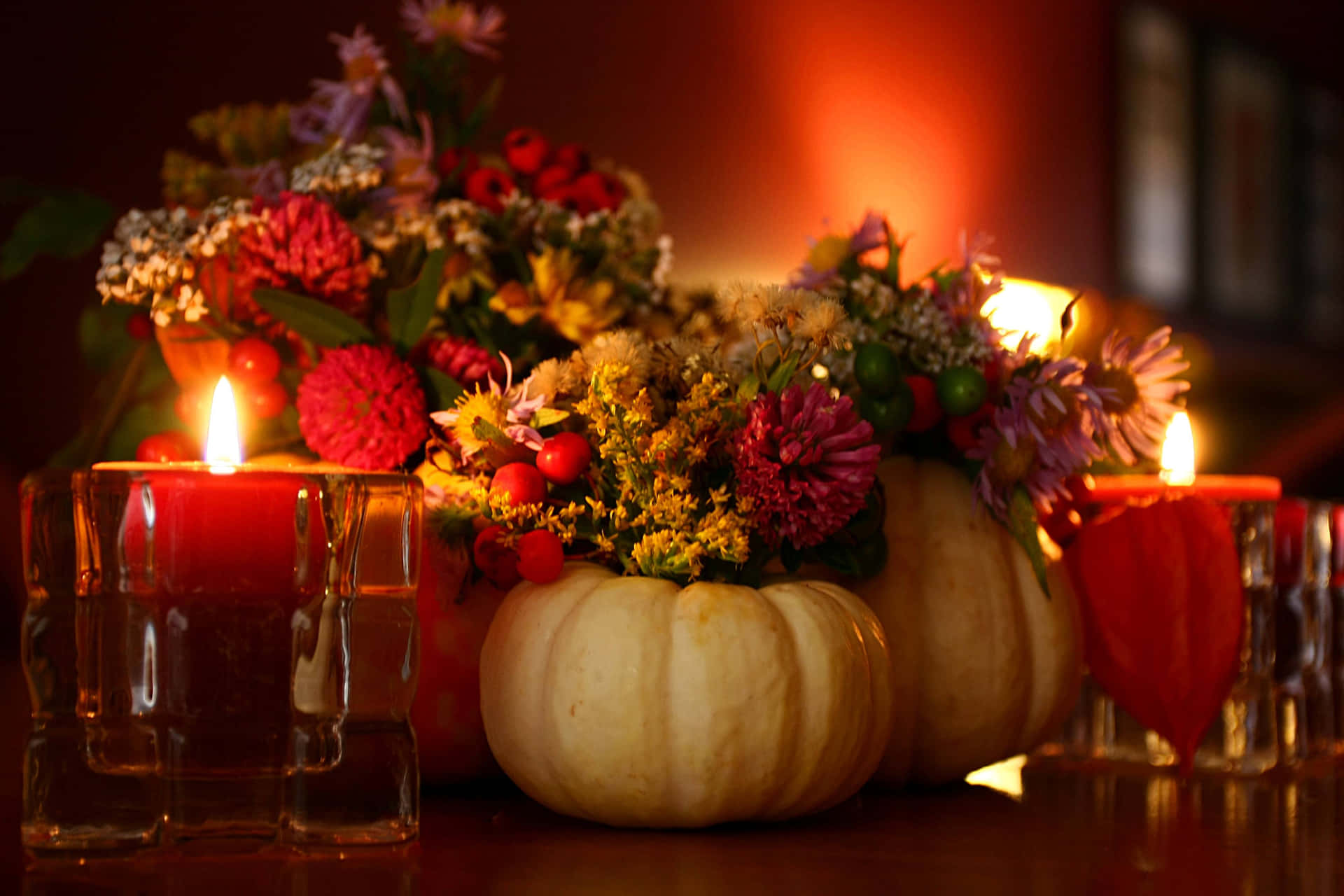 A Table With Candles And Flowers Background