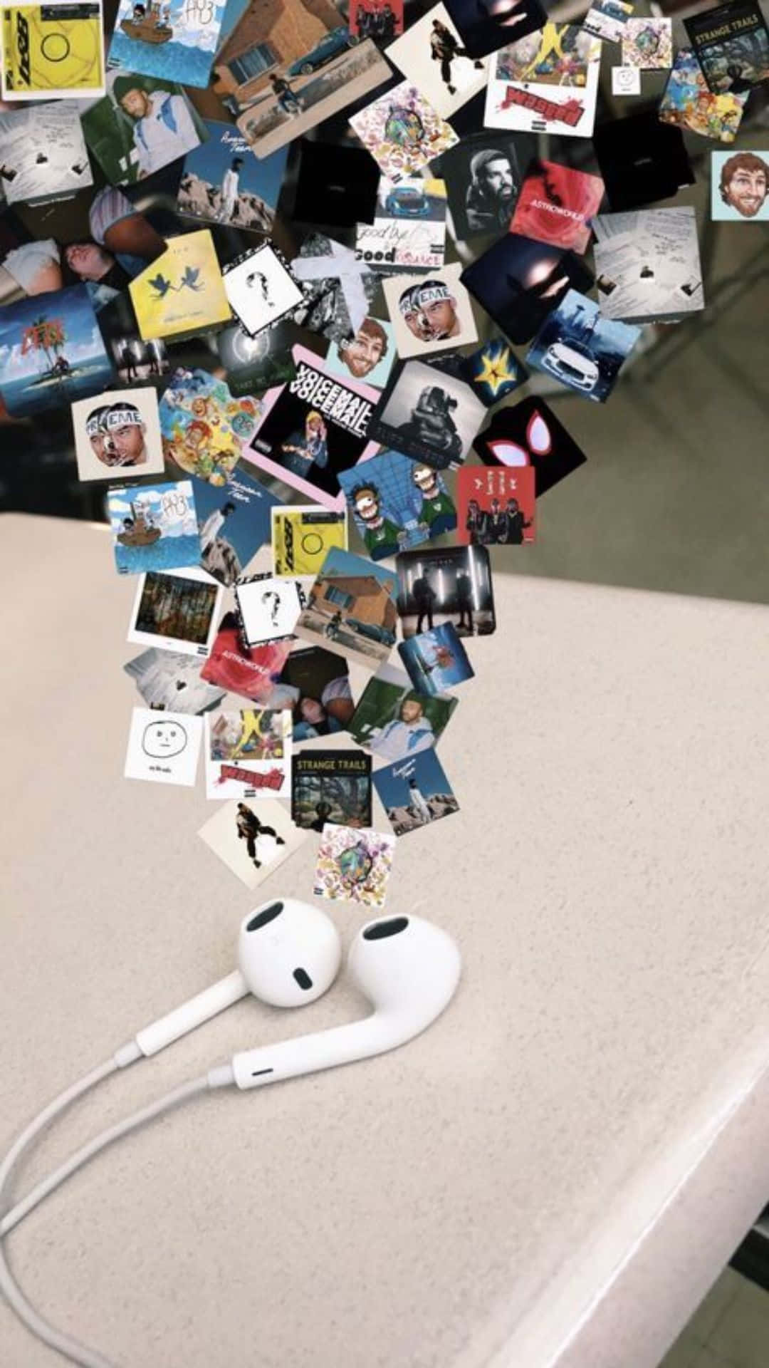 A Table With Earphones And Pictures Hanging From It