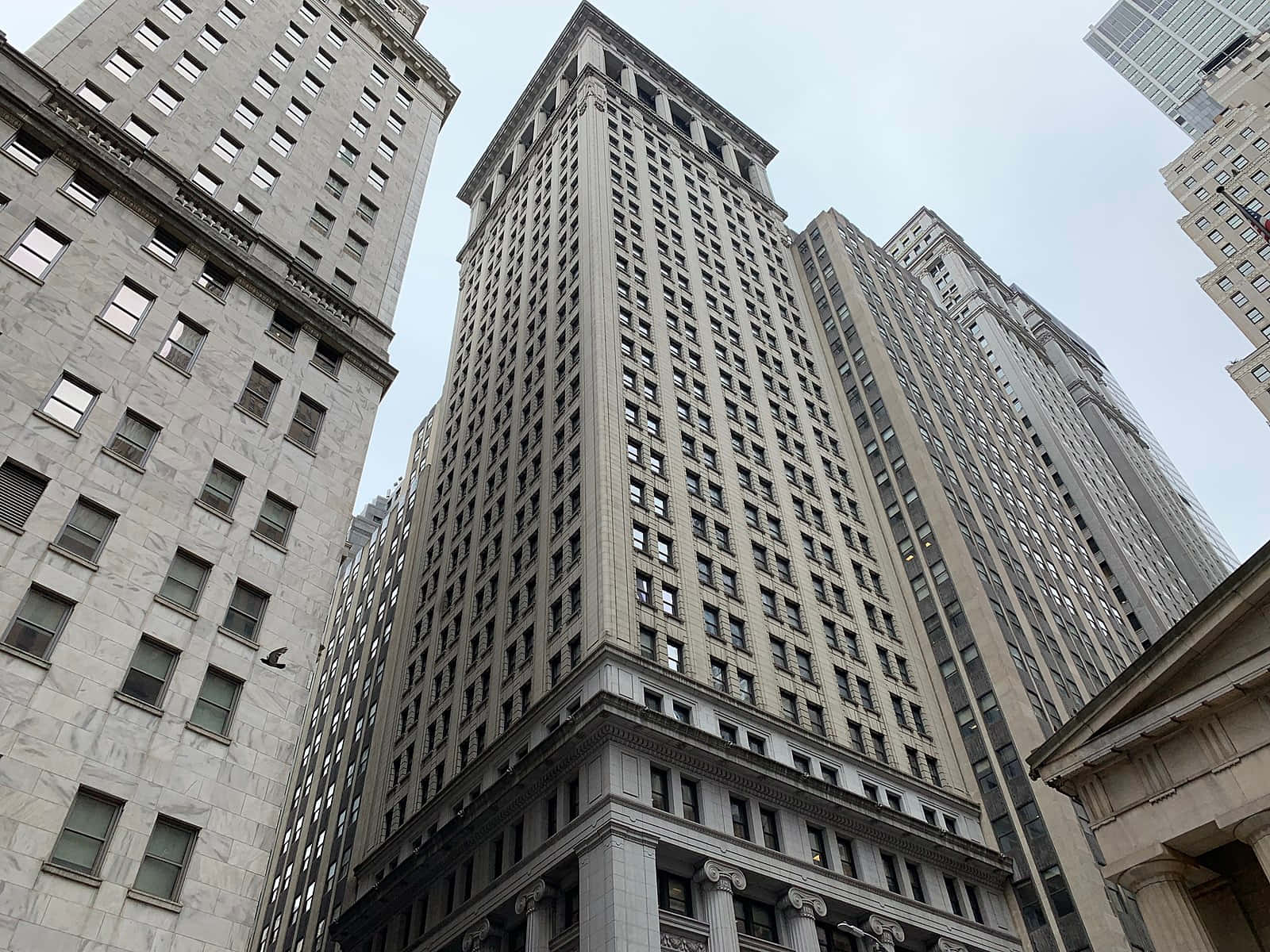 A Tall Building With Many Tall Buildings Background