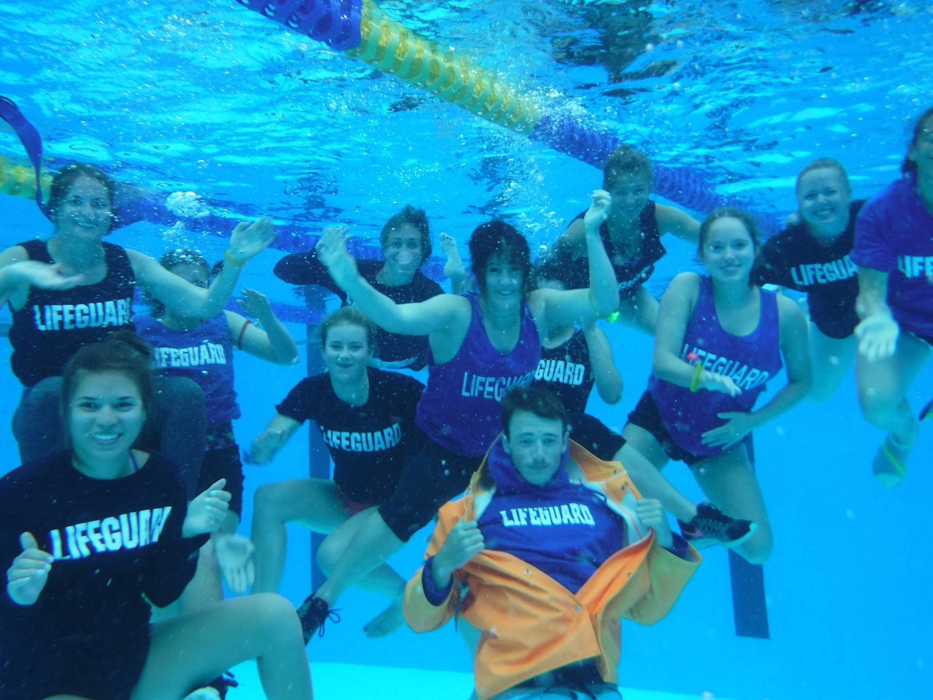 A Team Of Lifeguards Underwater Training Background